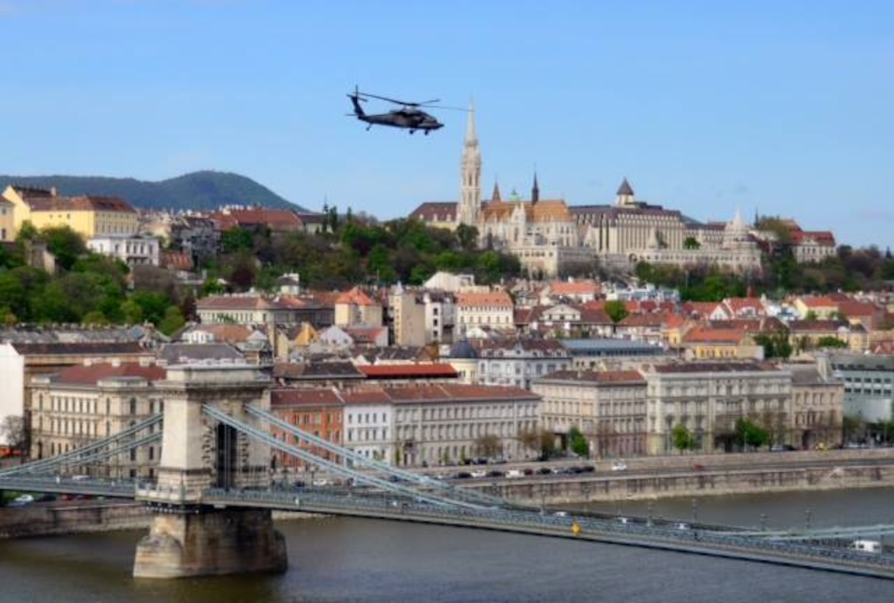 A UH-60 Black Hawk helicopter from the U.S. Army Europe's 12th Combat Aviation Brigade cruises over Budapest, Hungary, during Exercise Saker Falcon in April 2014. Defense Department officials have announced a restructuring of the brigade and subordinate units in Germany as part of the Army's Aviation Restructuring Initiative in Europe. U.S. Embassy Budapest photo by A. Reategui