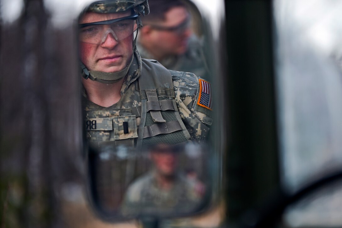 U.S. Army 1st Lt. Jonathan Briggs is seen in the mirror of his vehicle before a heavy weapons live-fire exercise on Joint Base Elmendorf-Richardson, Alaska, April 24, 2015. Briggs is assigned to the 25th Infantry Division's Company D, 1st Battalion, 501st Infantry Regiment, 4th Infantry Brigade Combat Team, Airborne, Alaska.