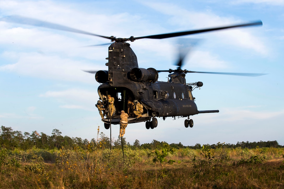 U.S. Army Green Berets fast-rope out of a CH-47 Chinook helicopter during insertion and extraction training as part of Emerald Warrior at Hurlburt Field, Fla., April 22, 2015. The Green Berets are assigned to the 7th Special Forces Group. 