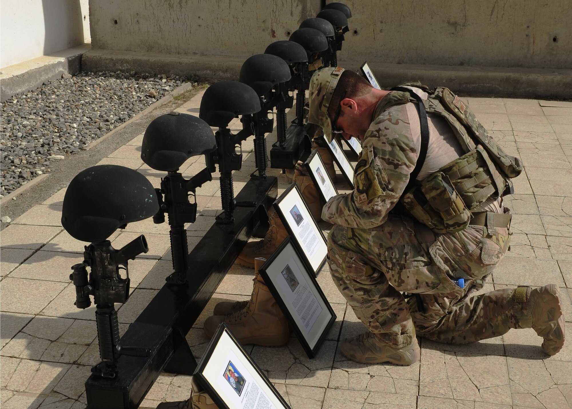 At the conclusion of a memorial ceremony, April 27, Col. Kent Landreth, Train, Advise, Assist Command – Air deputy commander, honors his fallen friend, Maj. Philip Ambard, who lost his life four years ago while serving in Afghanistan as an advisor to the Afghan Air Force.(U.S. Air Force photo/Capt. Jeff M. Nagan)