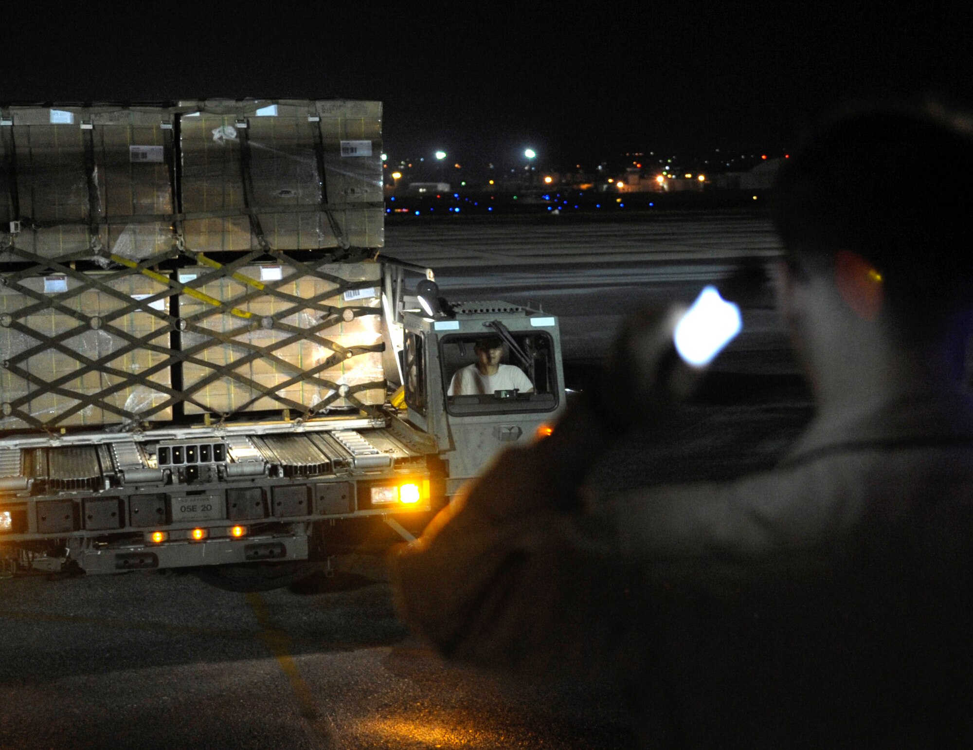 Air Force and Marine Corps personnel load gear for a U.S. Pacific Command Joint Humanitarian Assistance Survey Team onto a U.S. Marine Corps C-130 Hercules at Kadena Air Base, Japan, April 29, 2015. The survey team is deployed to Nepal to assist earthquake relief efforts. (U.S. Air Force photo/Airman 1st Class Zackary A. Henry)