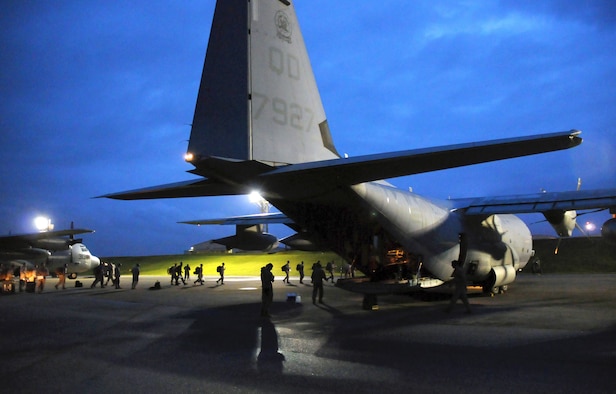Members of a U.S. Pacific Command Joint Humanitarian Assistance Survey Team load onto a U.S. Marine Corps C-130 Hercules at Kadena Air Base, Japan, April 29, 2015. The team is deploying to Nepal to assist earthquake relief efforts. Kadena’s Airmen worked through the night to load the team’s 20-plus members and gear for the departure. (U.S. Air Force photo/2nd Lt. Erik Anthony)