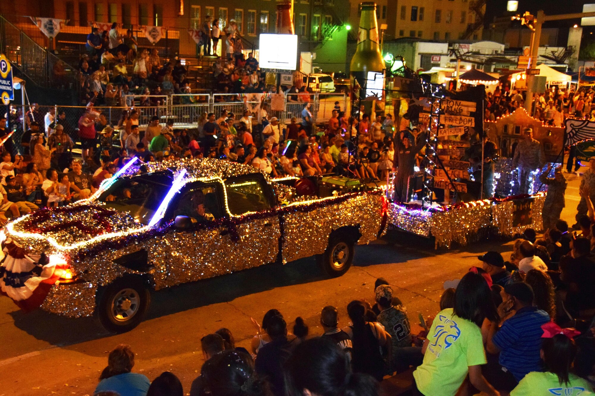 The 433rd Airlift Wing's "M*A*S*H” themed float moves through downtown San Antonio during the Fiesta Flambeau Parade, April 25, 2015. The parade's theme was “Television: Then and Now,” and according to the Fiesta San Antonio program is “America’s largest illuminated night parade.” Over 600,000 spectators lined the streets of San Antonio on a humid spring evening to see over 200 floats and marching bands perform in the grand finale of Fiesta Week. It is estimated 750,000 viewers (television and internet) watched this year's parade. (U.S. Air Force Photo/ Tech. Sgt. Carlos J. Trevino)
