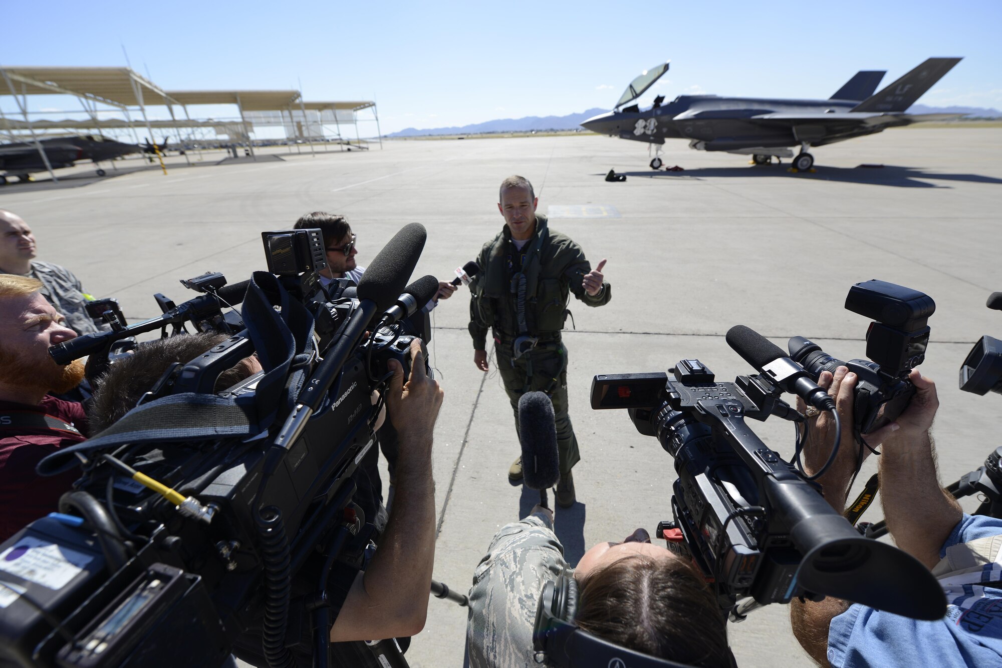 Brig. Gen. Scott Pleus, the 56th Fighter Wing commander, speaks with U.K. and Arizona-based media outlets after landing the flagship F-35 Lightning ll at Luke Air Force Base, Ariz., April 28, 2015. The flagship's arrival coincides with the start of Luke’s F-35 student pilot training, which begins in May. Luke now has 20 U.S. F-35s and two from the Royal Australian Air Force. (U.S. Air Force photo/Senior Airman Devante Williams)
