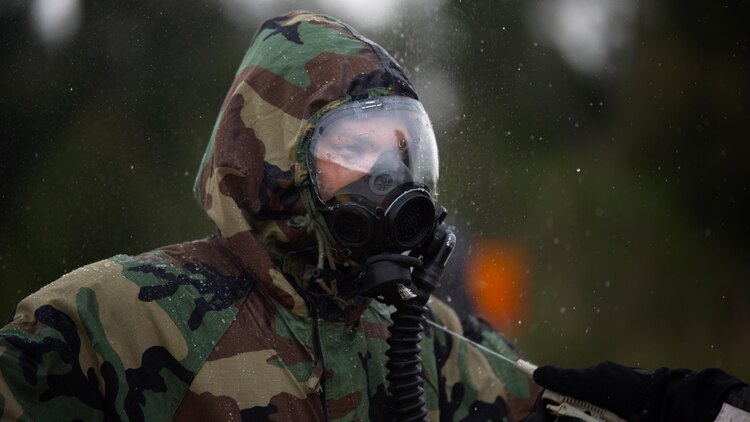 An explosive ordnance disposal technician undergoes the decontamination process after leak, seal, package and decontamination training April 21 at the gas chamber on Camp Hansen, Okinawa. Explosive ordnance disposal technicians and chemical, biological, radiological, nuclear defense specialists placed a leaking ordnance package in the gas chamber, using chlorobenzylidene malonitrile, also known as tear gas, to simulate the emission of harmful gases.  The EOD technicians and CBRN defense specialists used protective equipment to perform general decontamination of the affected area and prepare the leaking ordnance for safe containment and transport before completing the decontamination process. The training instilled the Marines’ confidence in their safety equipment and procedures used to mitigate CBRN-related hazards. The Marines are with 9th Engineer Support Battalion and Marine Logistics Group Headquarters Regiment, 3rd MLG, III Marine Expeditionary Force.
