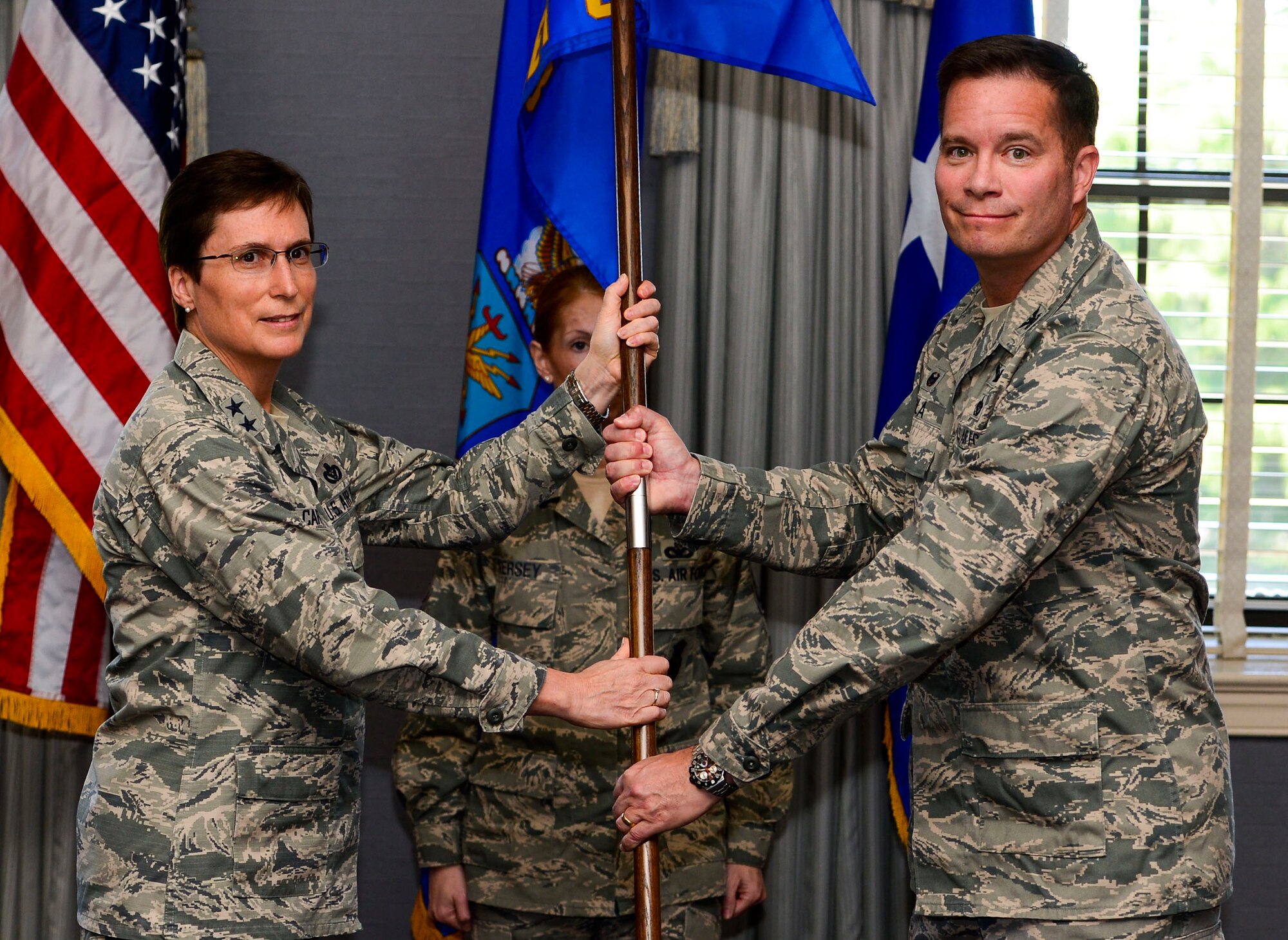 U.S. Air Force Maj. Gen. Theresa Carter, Air Force Installation and Mission Support Center commander, and Col. Russell Hula, participate in a ceremony marking Hula’s assumption of command of the detachment at Joint Base Langley-Eustis, Va., April 24, 2015. AFIMSC will perform major command-level installation and mission support activities, and serve as the single intermediate-level headquarters providing installation and expeditionary support to 77 major installations, 10 MAJCOMs and two direct reporting units. (U.S. Air Force photo/Senior Airman Kayla Newman/Released)