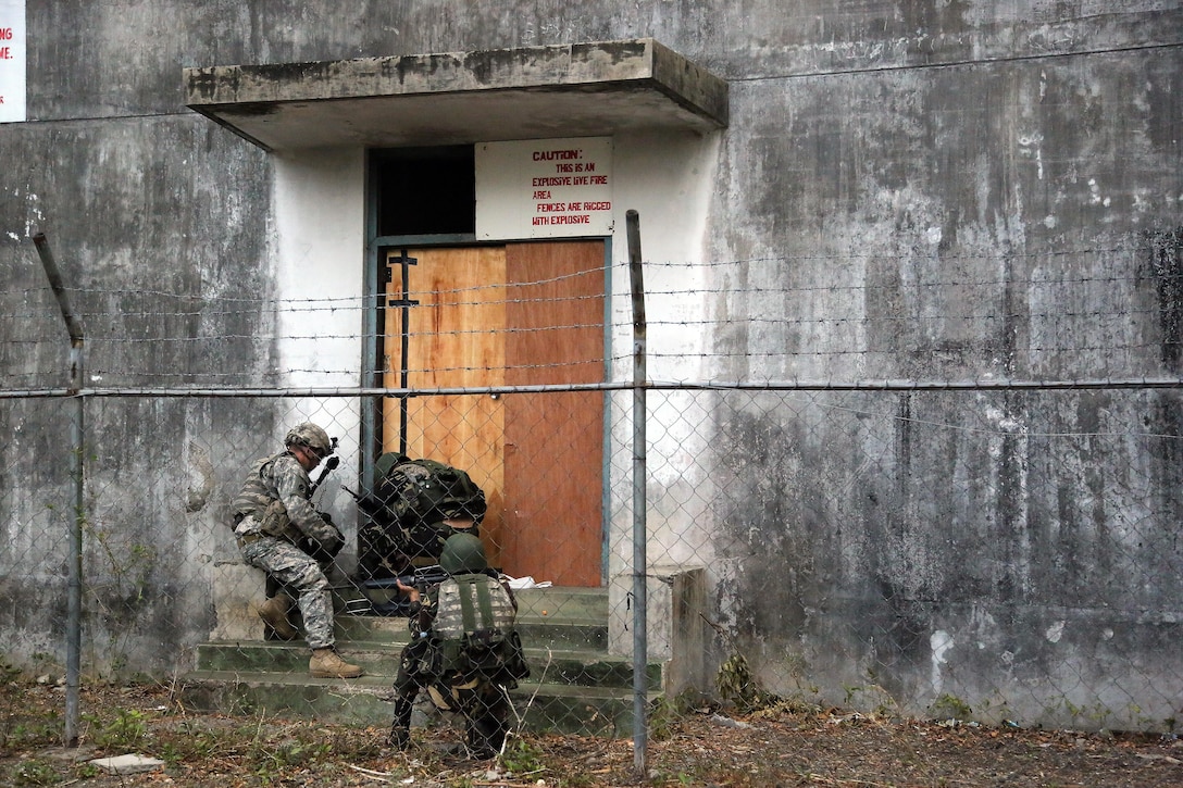 A U.S. Army Observer-Controller-Trainer monitor assigned to the Philippine Army’s 7th Infantry Division setup breaching explosives on a door during tactical-level field training as part of exercise Balikatan 2015 at Ft. Magsaysay, Philippines, April 23. U.S. Soldiers from 1st Battalion, 27th Infantry Regiment, which is a part of 2nd Stryker Brigade Combat Team, have been working shoulder-to-shoulder with Philippine soldiers from the 7ID during BK15. Bilateral training exercises, such as Balikatan, improve the readiness of both armed forces and helps maintain a high level of readiness, and enhances military-to-military relations and combined combat capabilities. 
