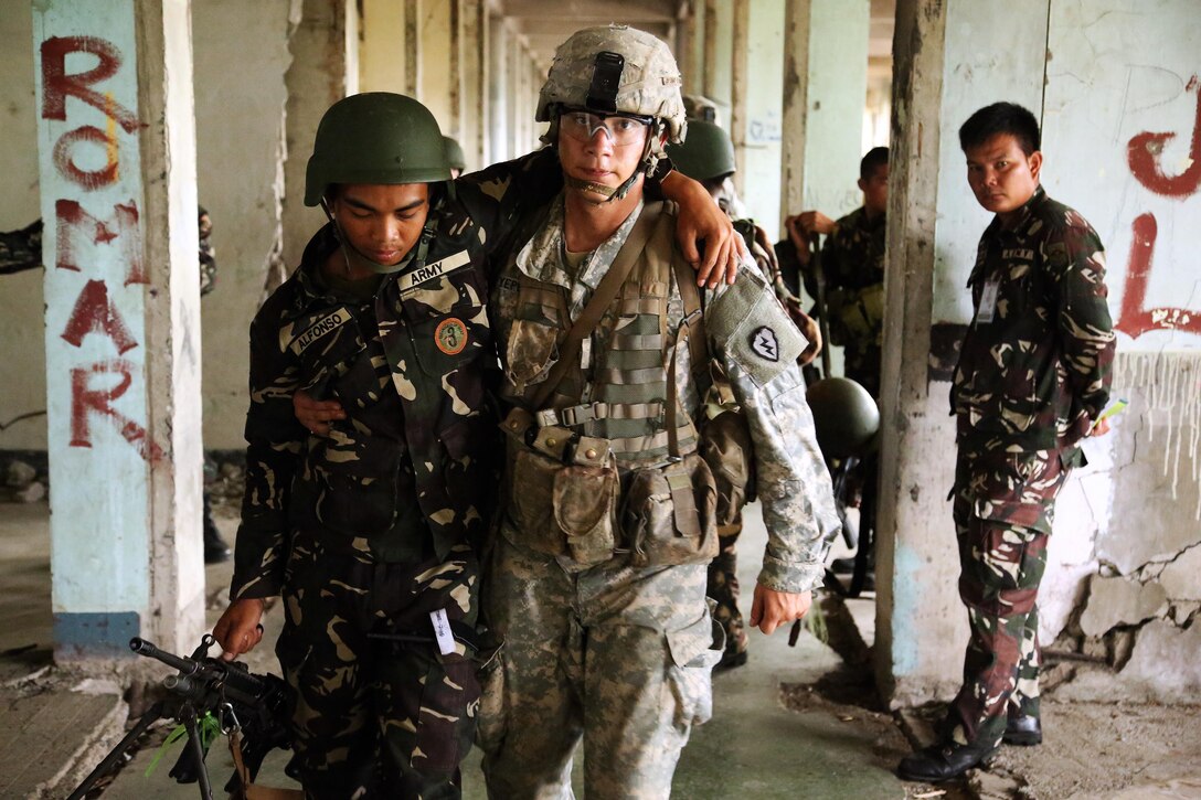 A Philippine Soldier assigned to the 7th Infantry Division and a U.S. Soldier 1st Battalion, 27th Infantry Regiment, performs casualty evacuation during field training at Ft. Magsaysay, Philippines, as part of exercise Balikatan 2015, April 23. U.S. Soldiers from 1-27, which is a part of 2nd Stryker Brigade Combat Team, have been working shoulder-to-shoulder with Philippine Soldiers from the 7ID during BK15. Bilateral training exercises, such as Balikatan, improve the readiness of both armed forces and helps maintain a high level of readiness, and enhances military-to-military relations and combined combat capabilities.