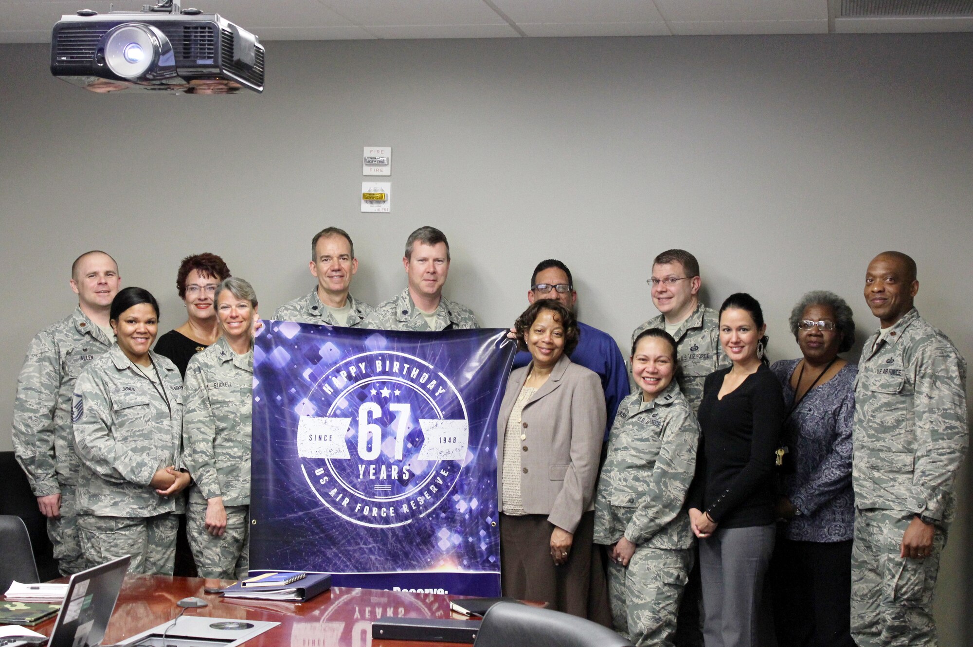 In honor of the Air Force Reserve's 67th anniversary, Air Reserve Personnel Center took photos with a commemorative banner at various events. Members of the Pretrained Individual Manpower group pose for a shot April, 9, 2015, on Buckley Air Force Base, Colo. (U.S. Air Force photo/Cindy Dewey)