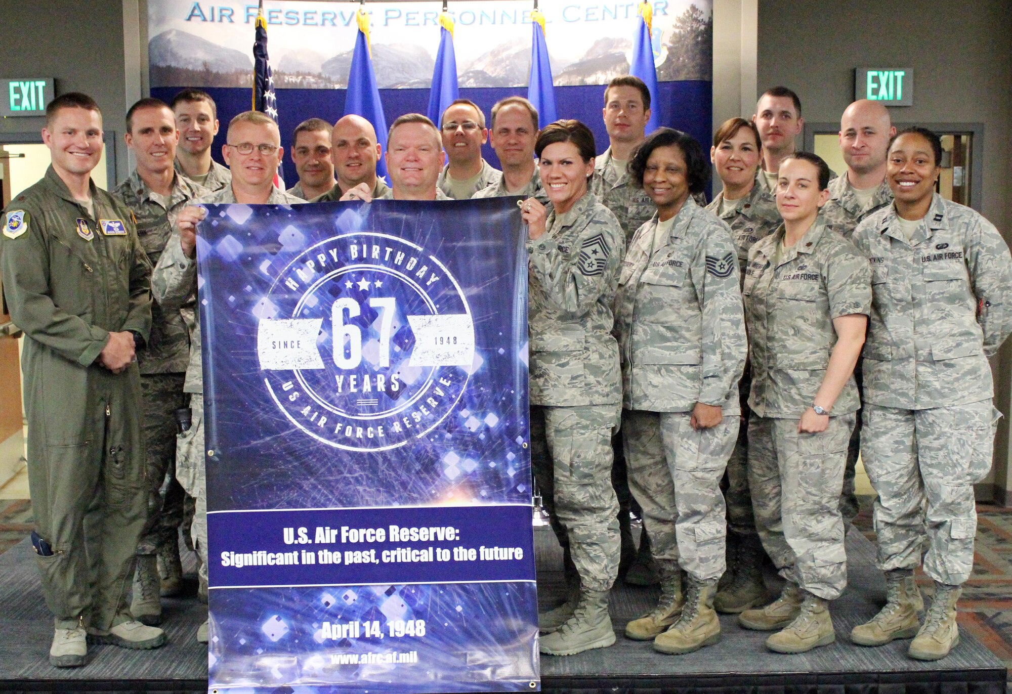 In honor of the Air Force Reserve's 67th anniversary, Air Reserve Personnel Center took photos with a commemorative banner at various events. Here, a group of members of ARPC pose for a shot during a porch call April 9, 2015, on Buckley Air Force, Base, Colo. (U.S. Air Force photos/Special photo)