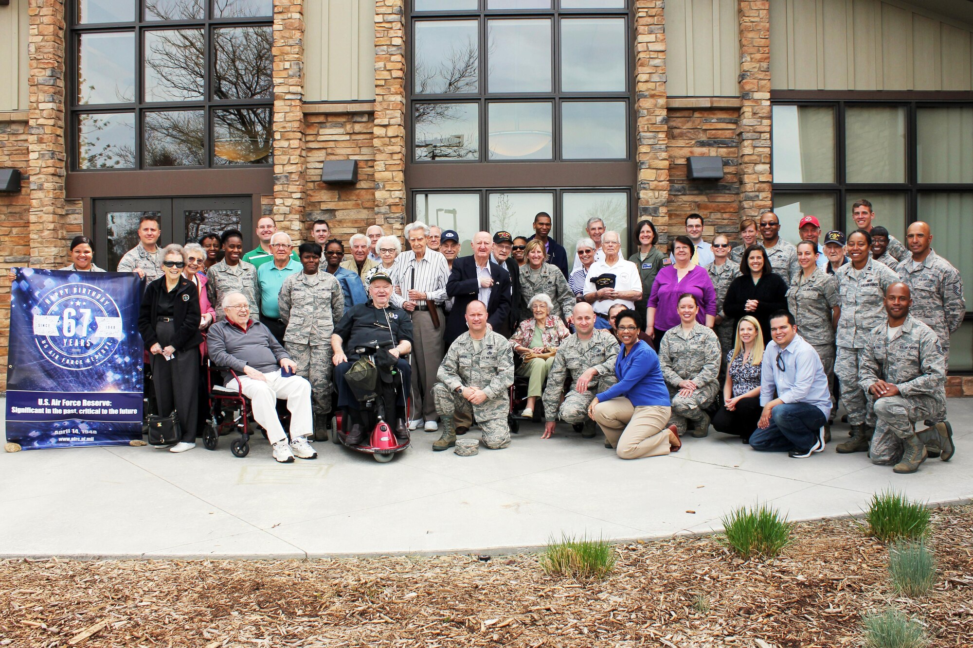 In honor of the Air Force Reserve's 67th anniversary, Air Reserve Personnel Center took photos with a commemorative banner at various events. Members of Headquarters Readiness & Integration Organization pose for a shot April 8, 2015, during a volunteer event at Heather Gardens in Aurora, Colo. (U.S. Air Force courtesy photo)