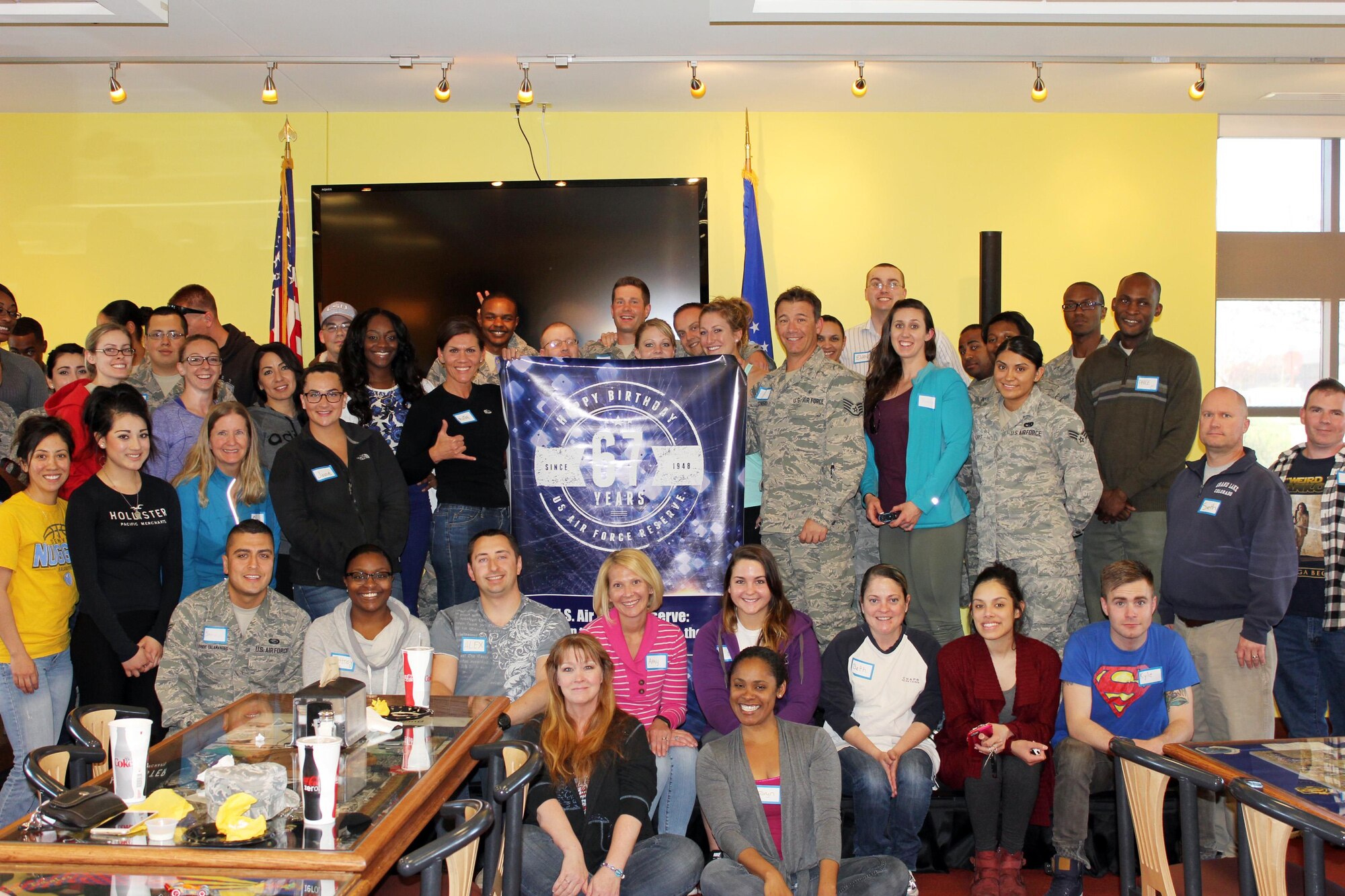 In honor of the Air Force Reserve's 67th anniversary, Air Reserve Personnel Center took photos with a commemorative banner at various events. Here, members from ARPC stand with the banner during a junior enlisted call hosted by Chief Master Sgt. Ruthe Flores, ARPC command chief, April 10, 2015, on Buckley Air Force Base, Colo. (U.S. Air Force courtesy photo)