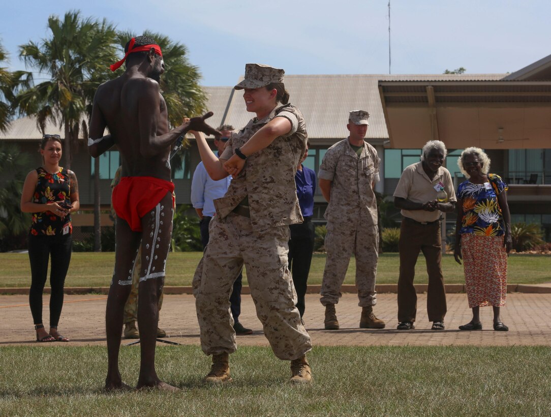 First Lieutenant Valerie Krygier, motor transport platoon commander, Combat Logistics Detachment 1, Marine Rotational Force – Darwin, dances with an aboriginal dancer with the Kenbi Dancers, during a “Welcome to Country” ceremony April 22 at Robertson Barracks, Palmerston, Australia. Brigadier Mick Ryan, commander, 1st Brigade, Australian Army, Australian Defence Force, spoke about the relationship between the Marines and Australians during the MRF-D deployment, and introduced Marines to aboriginal culture by inviting the Kenbi Dancers to conduct a welcoming performance.  MRF-D is the deployment of U.S. Marines to Darwin and the Northern Territory, for approximately six months at a time, where they will conduct exercises and training on a rotational basis with the ADF. (U.S. Marine Corps photo by Lance Cpl. Kathryn Howard/Released)
