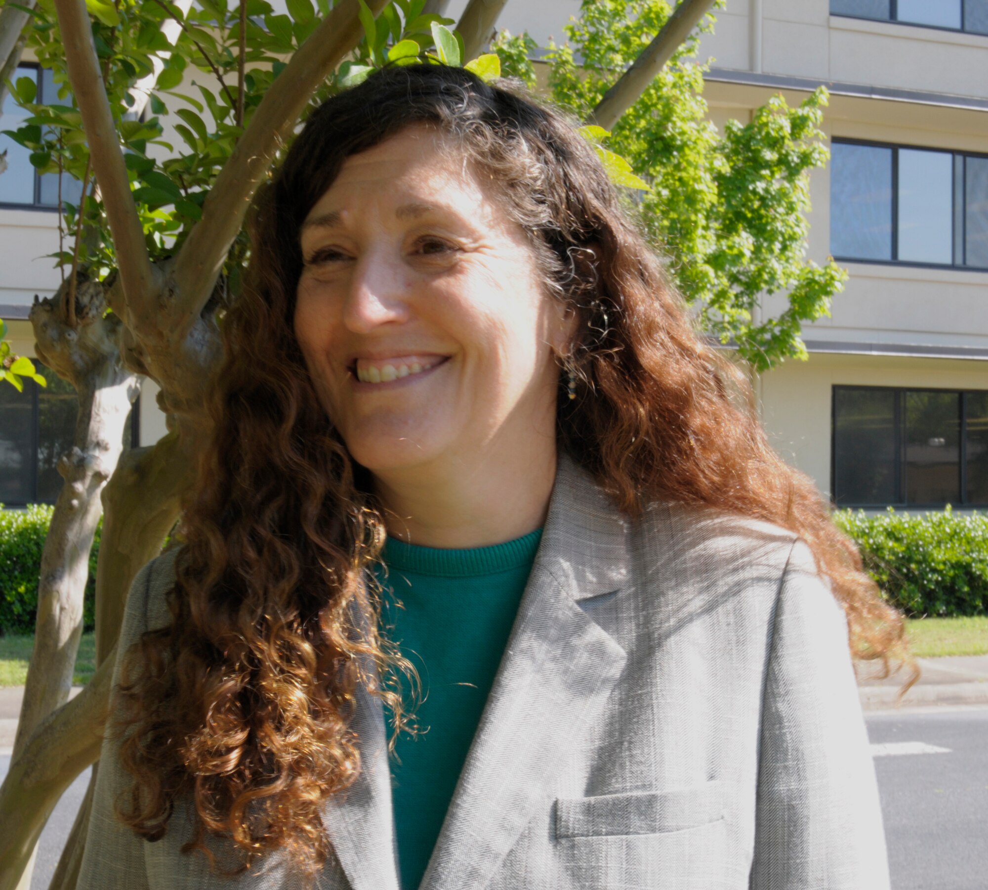 Patti Miller, Air Force Reserve Command program analyst, stands in front of her work building on Robins Air Force Base, Ga., April 29, 2015. Miller is within a few years of retirement, and would like to make a positive impact while she still serves. (U.S. Air Force photo by Staff Sgt. Sarah Hanson/RELEASED)