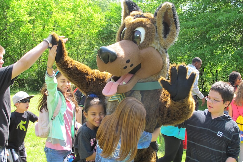 Sgt. Woof, a mascot for the Army Environmental Command, mixes and mingles with the children, emphasizing the 3Rs of unexploded ordnance safety:  Recognize, Retreat, Report.