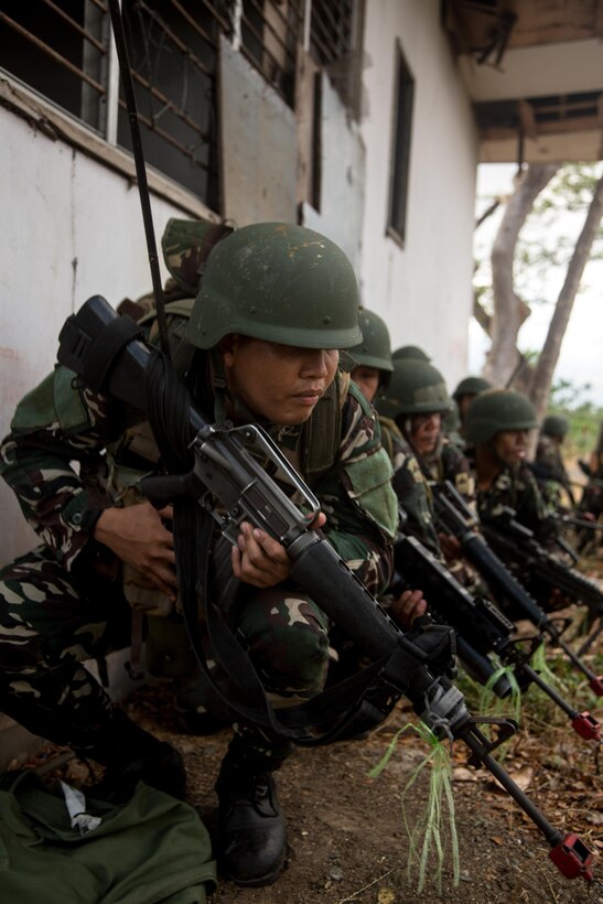 Philippine army soldiers assigned to the 7th Infantry Division prepare to assault the objective on a platoon live-fire exercise with U.S. Army Soldiers from the 25th Infantry Division during joint training exercise Balikatan 2015 at Fort Magsaysay, Philippines, April 23, 2015. Bilateral training exercises, such as Balikatan, improve the readiness of both armed forces, help maintain a high level of readiness, enhance military-to-military relations and combined combat capabilities.