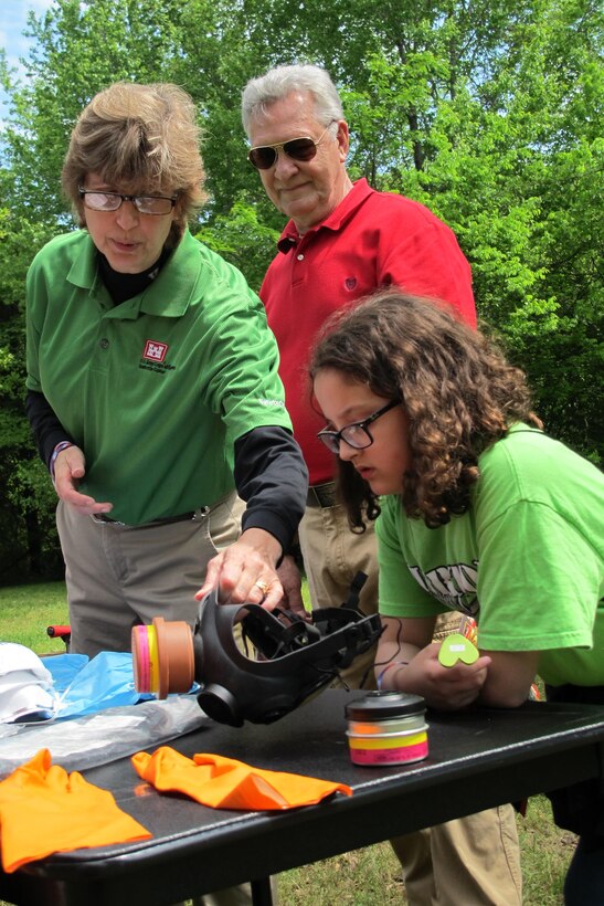 Huntsville Center safety workers, Kellie Williams and Charles Rollns talk to student about how safety equipment provides protection for humans during cleanup situations.