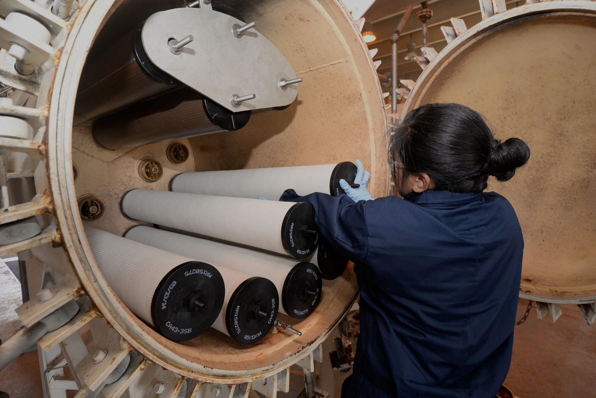 Staff Sgt. Staci Ducusin, 36th Civil Engineer Squadron water and fuels systems craftsman, replaces fuel filter separator elements to provide aircraft with clean fuel April 28, 2015, at a fuel hydrant pump house at Andersen Air Force Base, Guam. The section installs, inspects and maintains 600 facilities that include plumbing, liquid fuel storage, distribution and dispensing systems on base. (U.S. Air Force photo by Airman 1st Class Joshua Smoot/Released)