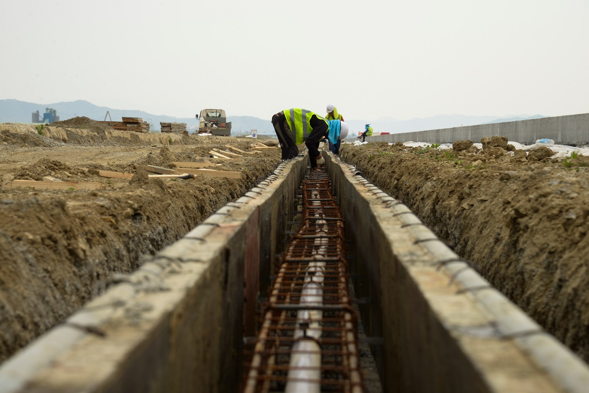 Republic of Korean contractors work on the second runway April 28, 2015, at Osan Air Base, Republic of Korea. The runway is being designed to buttress Team Osan's operations and alleviate stress on the base's single runway. (U.S. Air Force photo by Staff Sgt. Jake Barreiro/Released)