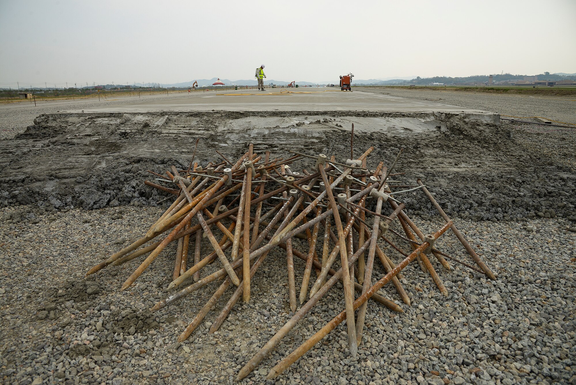 Republic of Korean contractors work on the second runway April 28, 2015, at Osan Air Base, Republic of Korea. The runway is being designed to buttress Team Osan's operations and alleviate stress on the base's single runway. (U.S. Air Force photo by Staff Sgt. Jake Barreiro/Released)