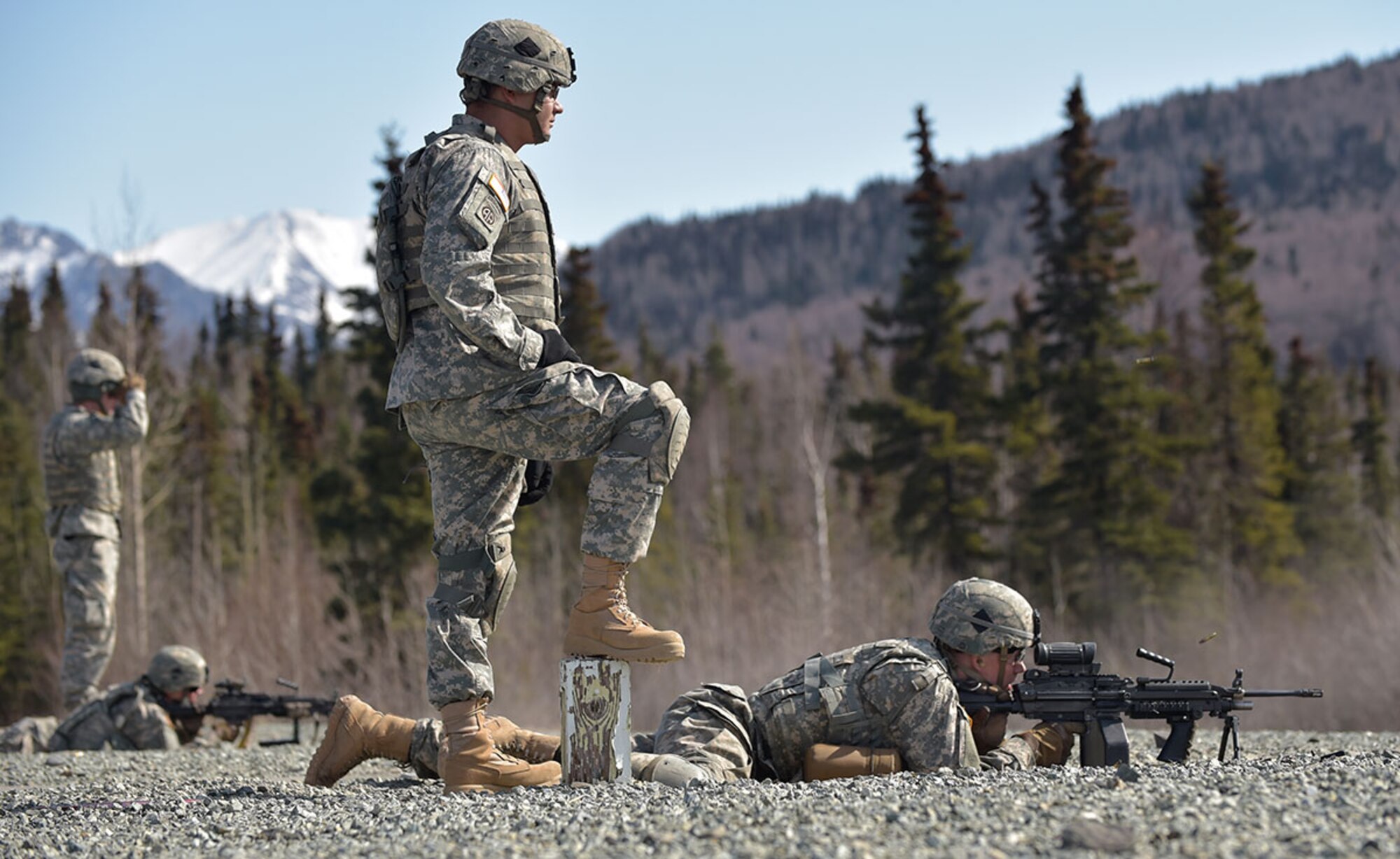 Army Sgt. Dusty Peevey, a native of Scotland, Texas, watches Army Pvt. Garrett Evans, a native of Williamsport, Pa., fire an M249 Squad Automatic Weapon at Grezelka range on Joint Base Elmendorf-Richardson, Thursday, April 23, 2015. Both paratroopers are assigned to Comanche Company, 1st Battalion (Airborne), 501st Infantry Regiment, 4th Infantry Brigade Combat Team (Airborne), U.S. Army Alaska. U.S. Army Alaska is home to the Army’s only Pacific airborne brigade combat team and maintains the only airborne rapid-response capacity within the Pacific Command. (U.S. Air Force photo/Justin Connaher)