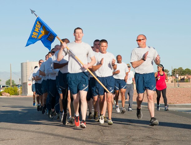Members of the 99th Security Forces Squadron run in formation during the Break the Silence 5Kat Nellis Air Force Base, Nev., April 17, 2015. The Family Advocacy Program, Sexual Assault Response Coordinator, and the Alcohol and Drug Abuse Prevention and Treatment program collaborated to provide public awareness for sexual assault, child abuse prevention, and alcohol awareness. (U.S. Air Force photo by Airman 1st Class Mikaley Towle)