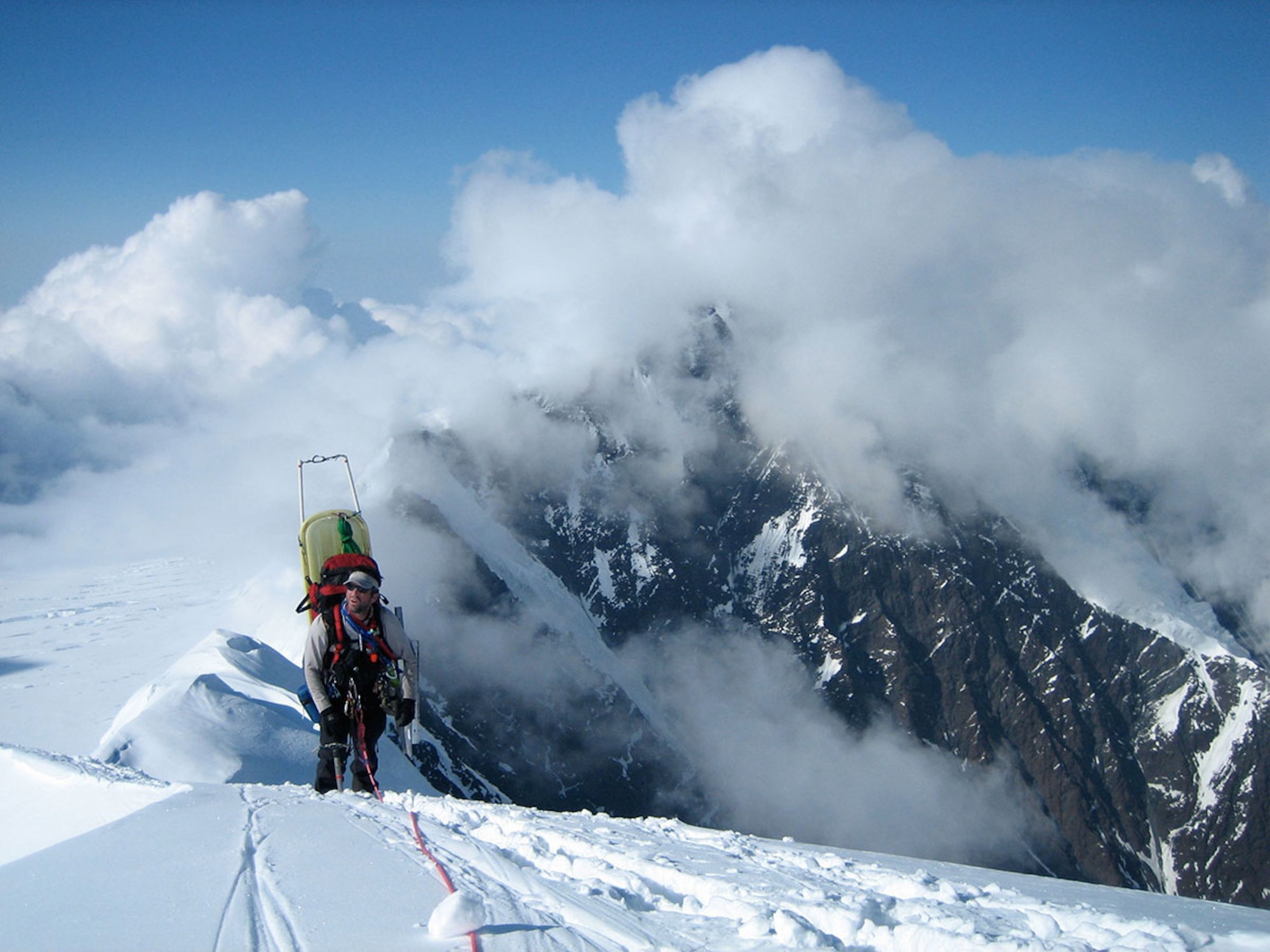 Senior Master Sgt. Doug Widener, a pararecueman from the 212th Rescue Squadron, Alaska Air National Guard, climbs the Karstens Ridge during a joint National Park Service/Alaska Air National Guard mountain patrol in the Denali Range of Alaska, in July 2005. Widener retired April 1 after 25 years in the Air Force, but plans to continue serving – with a new career in the Anchorage Fire Department. (Courtesy photo/Chris Roberts)