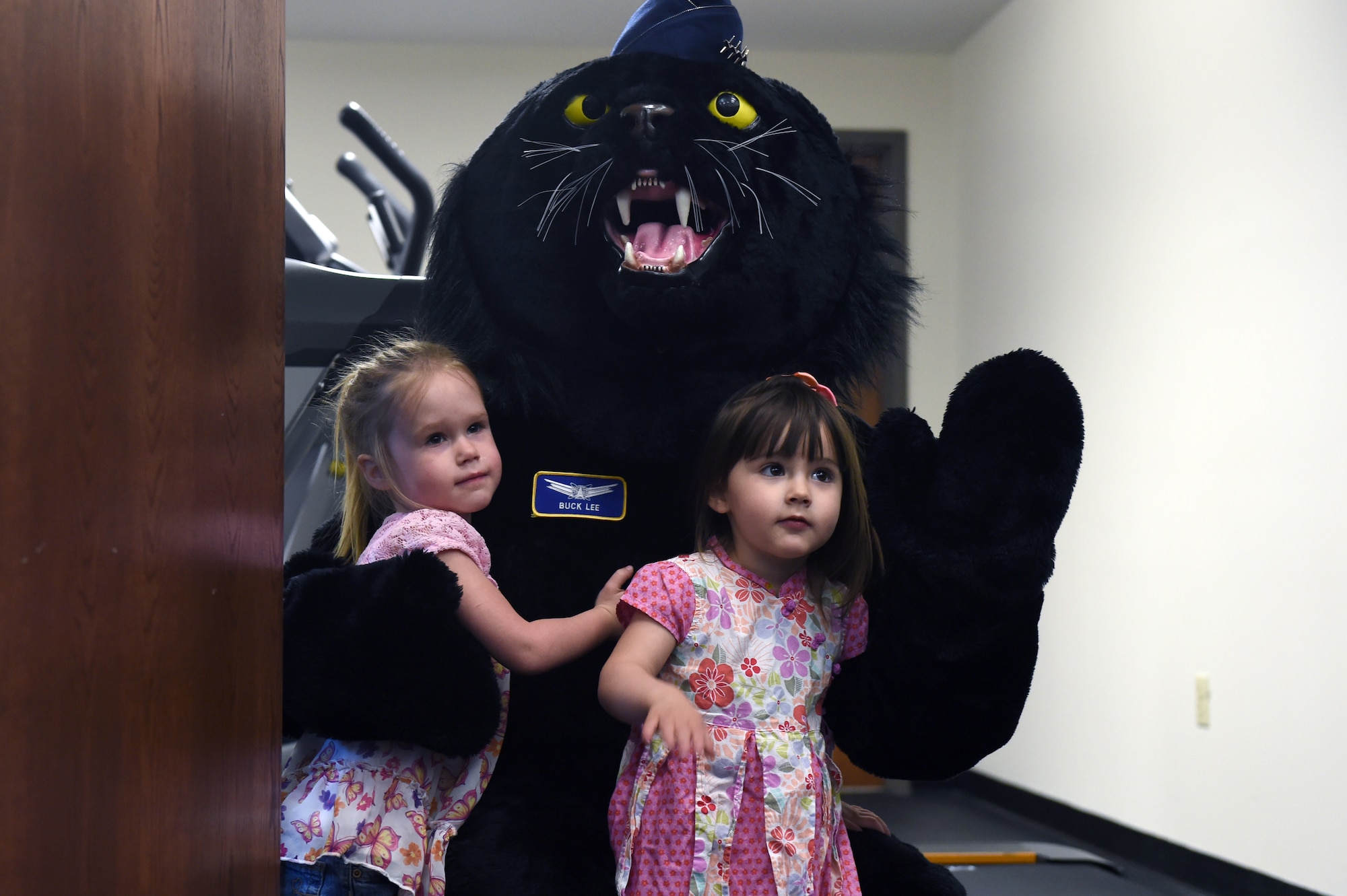 Buck Lee, 460th Space Wing mascot, makes a guest appearance at the grand opening of the Cub Corral April 30, 2015, in the fitness center on Buckley Air Force Base, Colo. The Cub Corral is a new workout room for parents to exercise while providing a place for their children to play. This room fixes the challenges that parents previously faced with living a fit life while also finding child care at the same time. Along with the Cub Corral, the fitness center is also opening up the Buck Stop, a food bar that will provide protein shakes, coffee and other snacks. (U.S. Air Force photo by Airman 1st Class Emily E. Amyotte/Released)