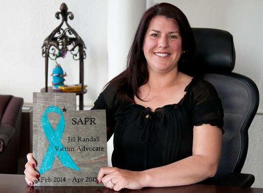 The new 90th Missile Wing Sexual Assault Response Coordinator, Jill Randall, displays her going away gift April 30, 2015, from Hill Air Force Base, Utah. The gift signifies her time at Hill AFB; however, she now beings her new journey at F.E. Warren AFB. (U.S. Air Force photo by Airman 1st Class Malcolm Mayfield)