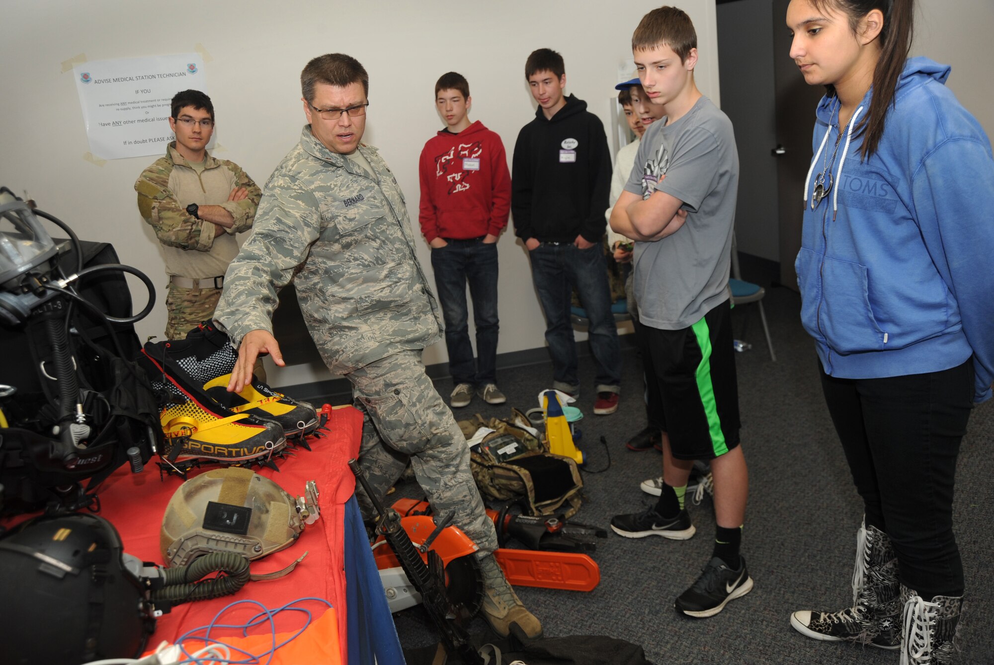 Air Force Maj. Chris Bernard, assigned to the 304th Rescue Squadron, Portland Air National Guard Base, Ore., describes most of the gear his team use to help in search and recovery efforts to a group of teenagers attending ‘Kids Day at PANG’, April 25, 2015. The Oregon National Guard opened the Portland Air Base to children of military members for a special day of activities highlighting “The Month of the Military Child,” designated since 1986 by the Department of Defense as way to recognize the contribution and personal sacrifices children make to the military. (U.S. Air National Guard photo by Tech. Sgt. John Hughel, 142nd Fighter Wing Public Affairs/Released)