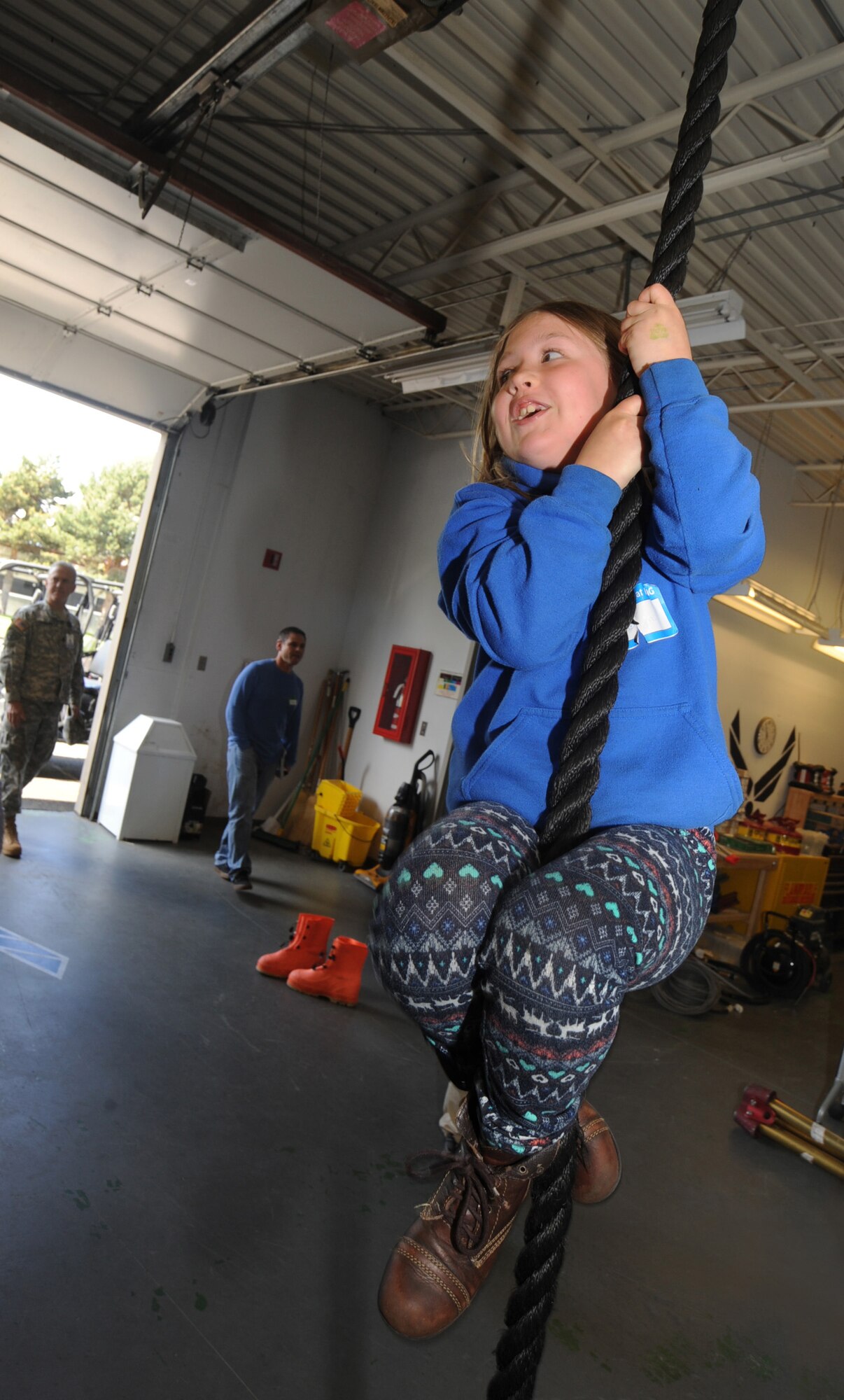 A child attempts to climb a rope used for training by members of the Oregon Air National during ‘Kids Day at PANG’ April 25, 2015, Portland Air National Guard Base, Ore.  The Oregon National Guard opened the Portland Air Base to children of military members for a special day of activities highlighting “The Month of the Military Child,” designated since 1986 by the Department of Defense as way to recognize the contribution and personal sacrifices children make to the military. (U.S. Air National Guard photo by Tech. Sgt. John Hughel, 142nd Fighter Wing Public Affairs/Released)