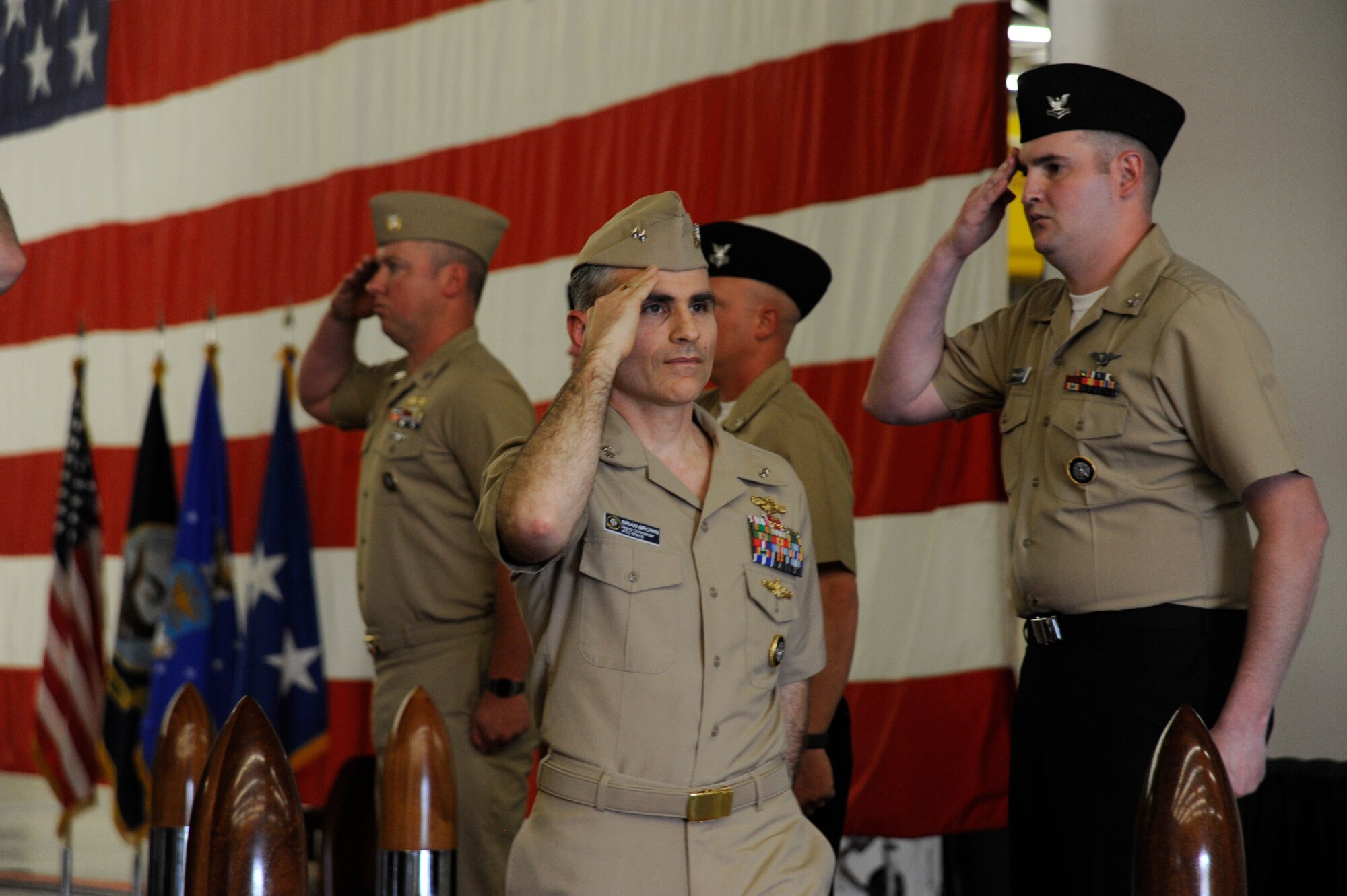 Sailors salute U.S. Navy Rear Adm. Brian B. Brown, deputy commander, Joint Functional Component Command for Space, as he departs his promotion ceremony, April 29, 2015, Vandenberg Air Force Base, Calif. Family members and guests from VAFB were present for the ceremony. (U.S. Air Force Photo by Airman 1st Class Robert J. Volio/Released)