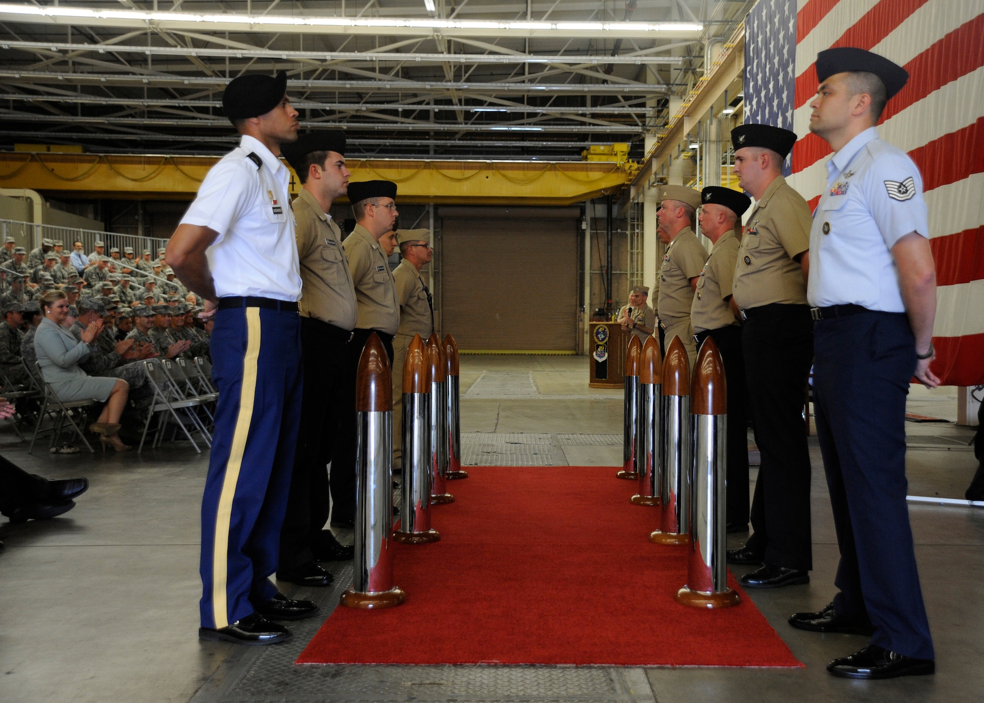 Military members stand at parade rest while U.S. Navy Rear Adm. Brian B. Brown, deputy commander, Joint Functional Component Command for Space, speaks to members in attendance during his promotion ceremony, April 29, 2015, Vandenberg Air Force Base, Calif. Family members and guests from VAFB were present for the ceremony. (U.S. Air Force Photo by Airman 1st Class Robert J. Volio/Released)