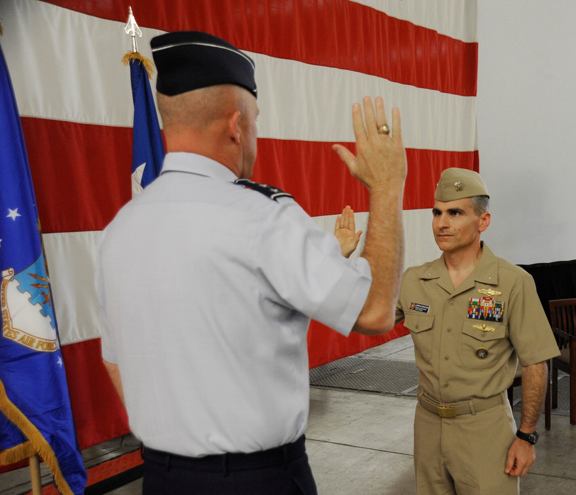 Lt. Gen. John W. “Jay” Raymond, commander, 14th Air Force (Air Forces Strategic) and Joint Functional Component Command for Space, administers the Oath of Office to U.S. Navy Rear Adm. Brian B. Brown, deputy commander, JFCC Space, during Brown’s promotion ceremony, April 29, 2015, Vandenberg Air Force Base, Calif. Family members and guests from VAFB were present for the ceremony. (U.S. Air Force Photo by Airman 1st Class Robert J. Volio/Released)