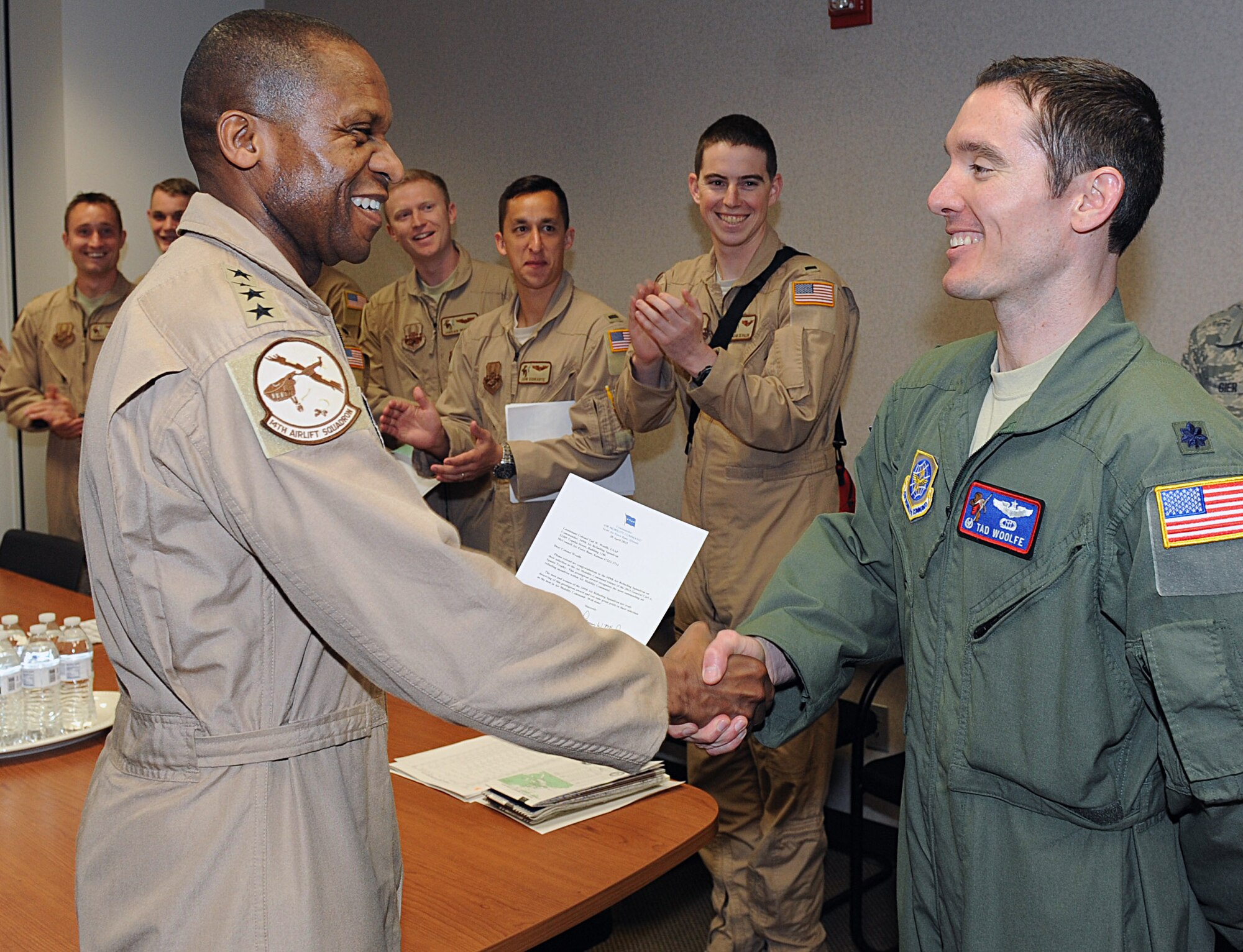 Gen. Darren McDew, Air Mobility Command commander, presents a letter of recognition to Lt. Col. Tad Woolfe, 349th Air Refueling Squadron commander, April 20, 2015, at McConnell Air Force Base, Kan. The 349th ARS “Bandits” were awarded the Gen. Carl A. Spaatz Trophy for the third time in seven years. The Spaatz Trophy recognizes the best of the best in aerial refueling in the Air Force, with the “Bandits” representing AMC for 2014. (U.S. Air Force photo by Senior Airman David Bernal Del Agua)