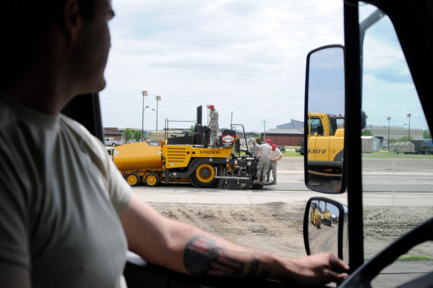 Tech. Sgt. Eric Jones looks on as Air National Guard civil engineers hone their asphalt paving skills at Ebbing ANG, Base, Ark., April, 21,2015. Airmen from the 188th Civil Engineer Squadron and the Ohio Air National Guard’s 200th Rapid Engineer Deployable Heavy Operational Repair Squadron Engineer Squadron completed milling and asphalt training over the course of two weeks. Engineers must recertify these skills every three years. Jones is assigned to the 188th CES. (U.S. Air National Guard photo by Staff Sgt. Hannah Dickerson/released)