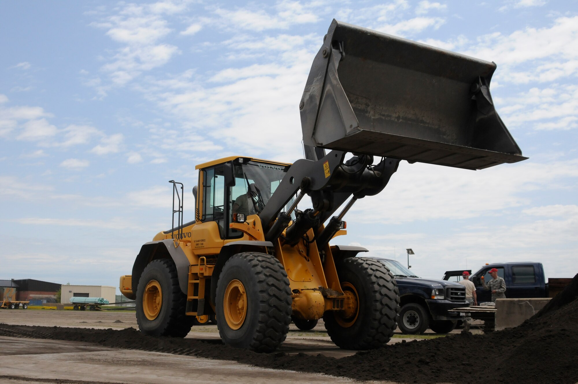 Master Sgt. Bryan Sutton prepares to load crusher dust at Ebbing Air National Guard Base, Ark., during annual training, April 21, 2015. Crusher dust is utilized during asphalt training to teach the proper techniques and procedures when laying asphalt. Sutton is assigned to the 188th Civil Engineer Squadron. (U.S. Air National Guard photo by Staff Sgt. Hannah Dickerson/released)