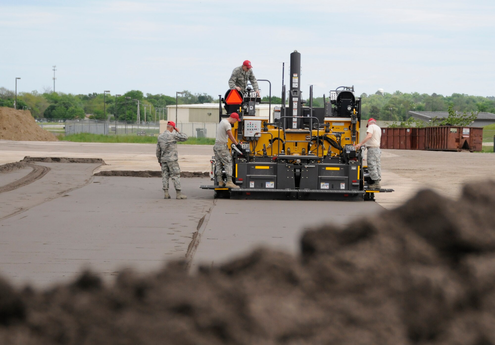 Air National Guardsmen partake in asphalt paving training April 21, 2015, during annual training at Ebbing Air National Guard Base, Ark. Airmen from the 188th Civil Engineer Squadron and the Ohio Air National Guard’s 200th Rapid Engineer Deployable Heavy Operational Repair Squadron Engineer Squadron completed milling and asphalt training over the course of two weeks. Engineers must recertify these skills every three years. (U.S. Air National Guard photo by Staff Sgt. Hannah Dickerson/released)