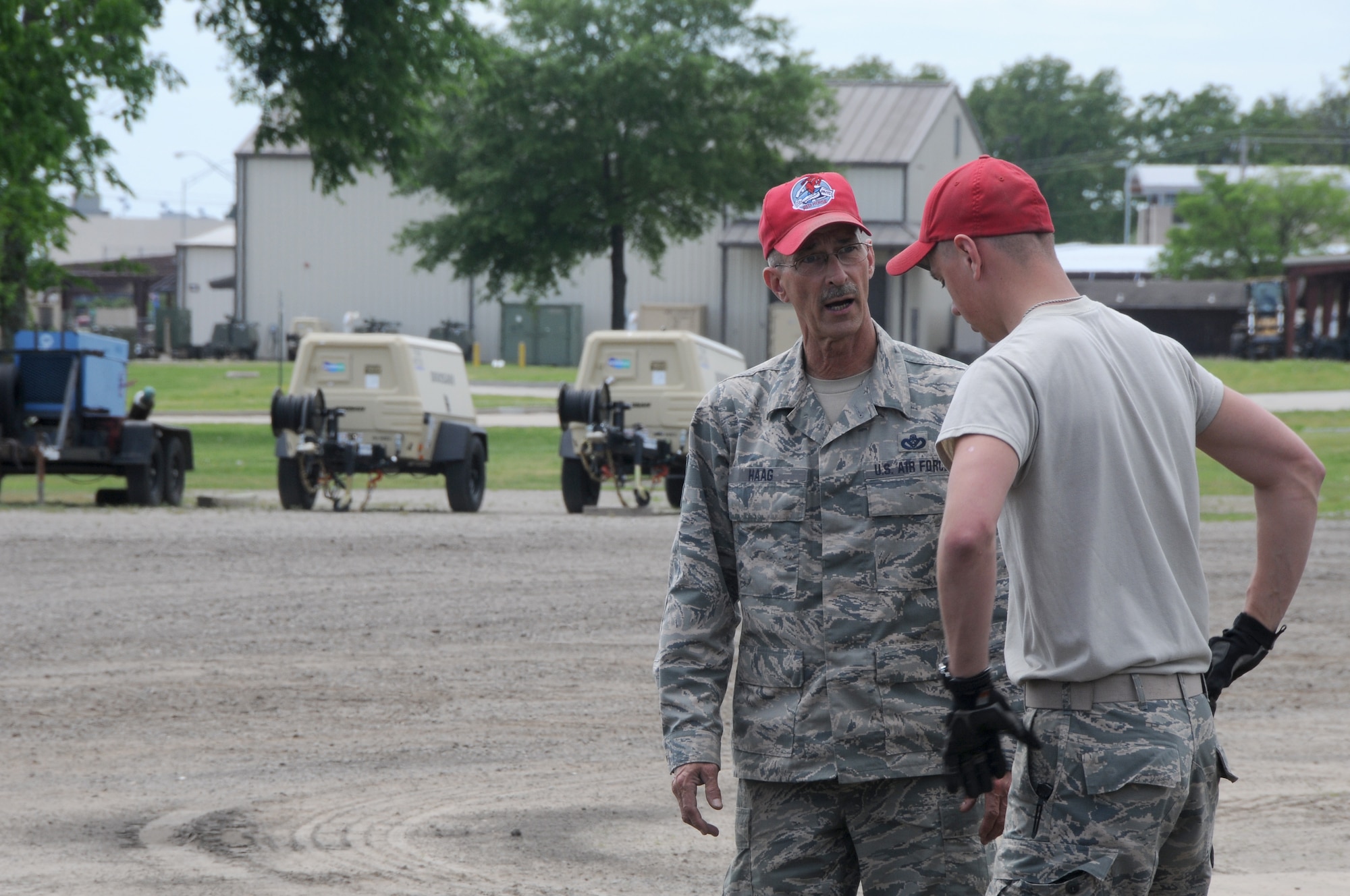 Senior Master Sgt. Robert Haag II, rapid engineer deployable heavy operational repair squadron engineer (REDHORSE) training center senior instructor speaks with Airman 1st Class Andrew Sneeringer, member of the 200th REDHORSE Squadron, during asphalt training provided at Ebbing Air National Guard Base, Fort Smith, Ark., April 21, 2015. The 188th RHTC provided asphalt training from April 21-24. (U.S. Air National Guard photo by Senior Airman Cody Martin/released)
