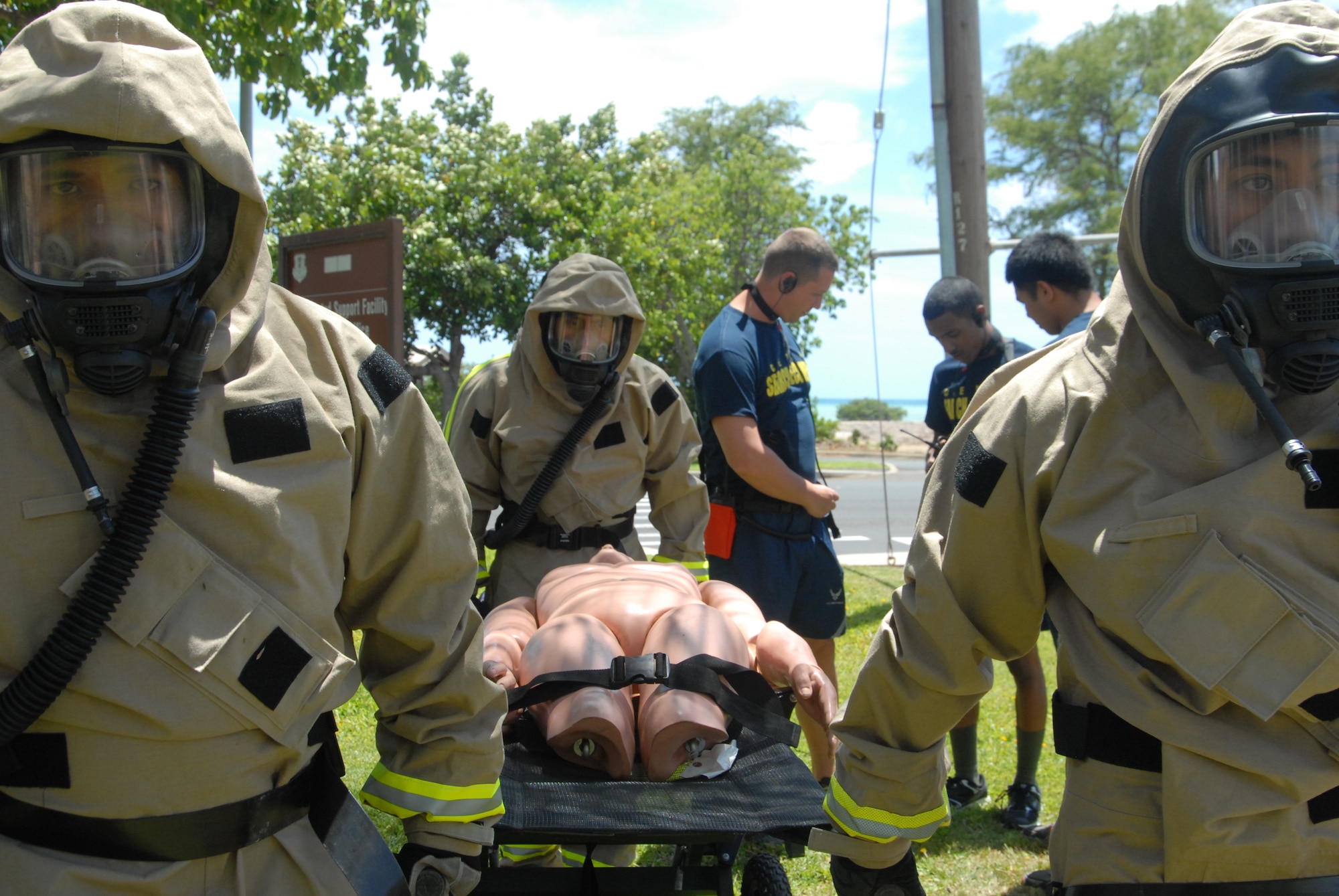 Members of the Hawaii Air National Guard's Fatality, Search, and Recovery Team practice fatality transport while having Powered Air Respirator suits donned at Joint Base Pearl Harbor-Hickam, Hawaii, April 29, 2015. The FSR team is comprised of airmen from the 154th Force Support Squadron. The airmen are prepping for a Vigilant Guard emergency response exercise scheduled to take place this summer. (U.S. Air National Guard photo by Senior Airman Orlando Corpuz/Released)