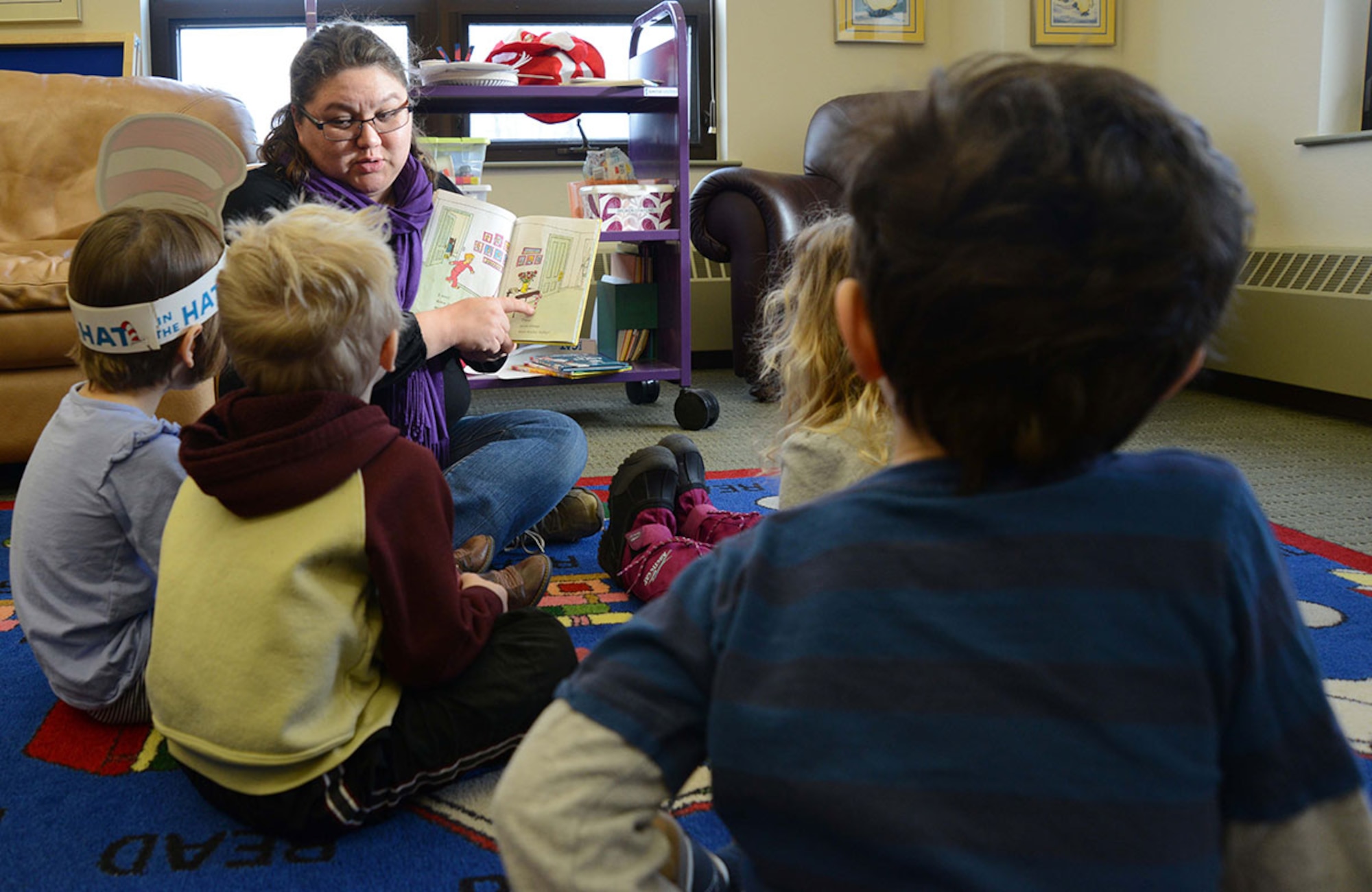 Tesha Mulkey, 673d Force Support Squadron library technician, reads to children at the Consolidated Library on March 3. (Air Force photo/Airman Christopher R. Morales)
