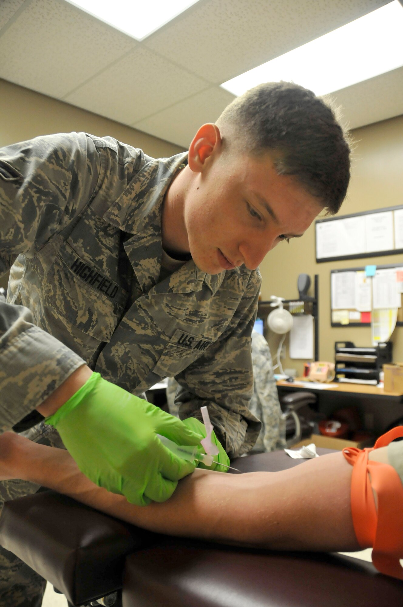 Airman 1st Class Bryant Highfield, 188th Medical Group aerospace medical technician, prepares to draw blood from a fellow 188th Airman in the MDG laboratory at Ebbing Air National Guard Base, Fort Smith, Ark., during the April unit training assembly, April 11, 2015. Highfield's superiors and peers noted his exceptional work ethic, leading to his selection as the May 2015 The Flying Razorback spotlight. (U.S. Air National Guard photo by Staff Sgt. John Suleski/released)