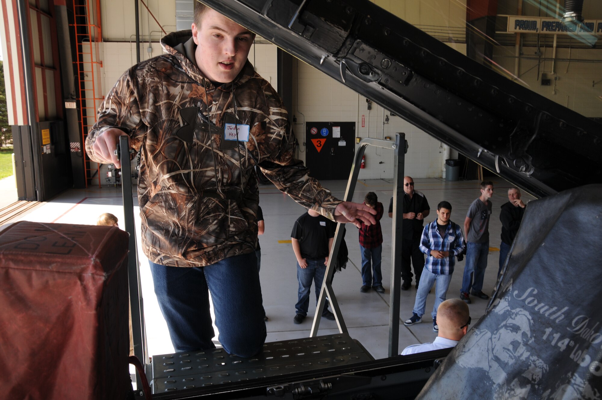 Jordon Heyd, a junior from Canistota, S.D., looks inside an F-16 Fighting Falcon cockpit during the 2015 South Dakota Air National Guard Career Day at Joe Foss Field, S.D., April 29, 2015. The event was held to showcase the many careers within the South Dakota Air National Guard to area high school seniors and juniors.  (National Guard photo by Senior Airman Duane Duimstra/Released)