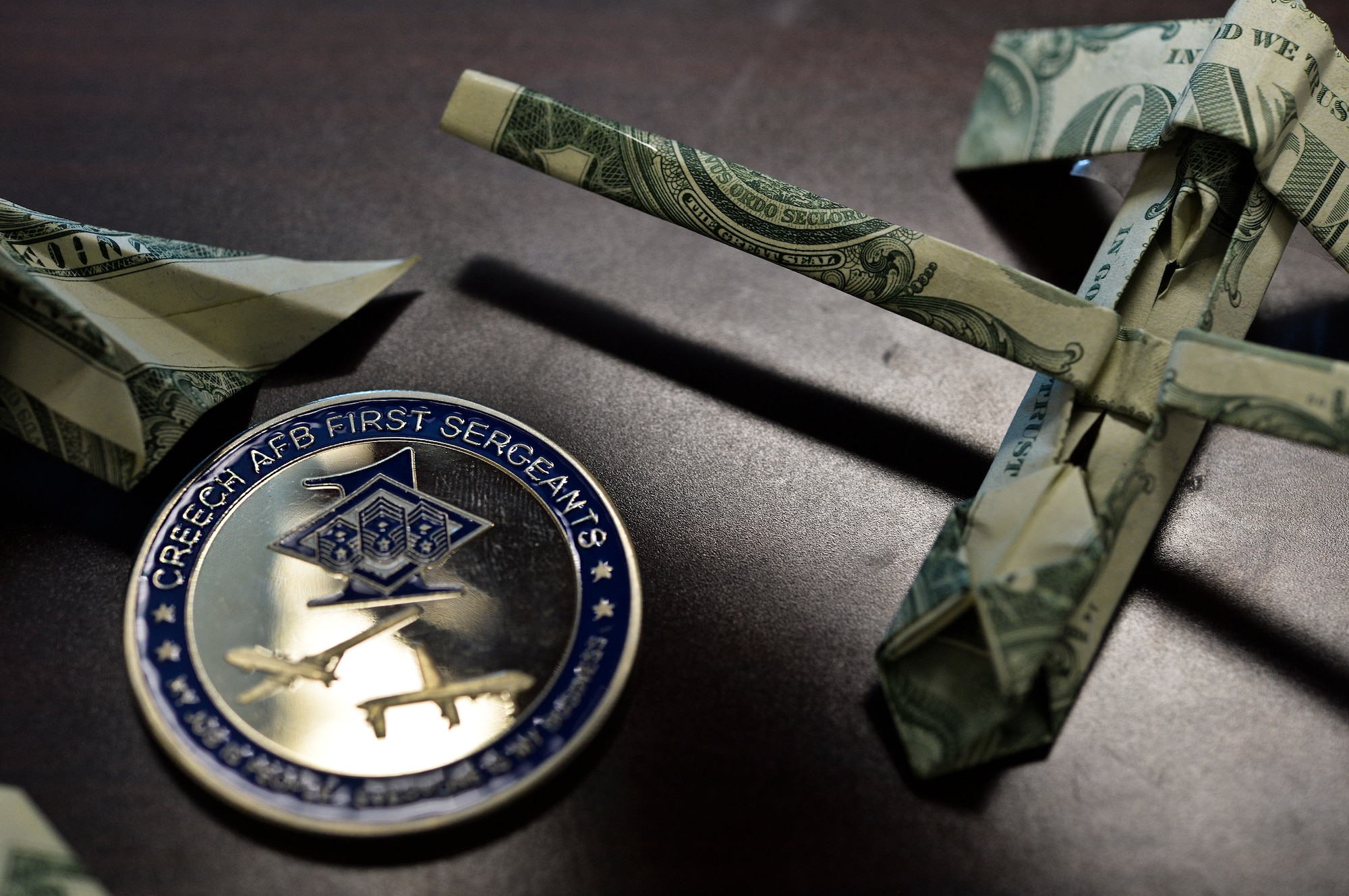 An MQ-1 Predator replica sits on the desk of Master Sgt. Timothy Serrano, 432nd Aircraft Communications Maintenance Squadron first sergeant, April 6, 2015 at Creech Air Force Base, Nevada. This piece is especially special to the 432nd Wing/432nd Air Expeditionary Wing since it flies both the MQ-1 Predator and the MQ-9 Reaper remotely piloted aircraft. According to Serrano, the MQ-1 was one of his most challenging pieces to recreate but one he’s proud to have overcome.  (U.S. Air Force photo by Senior Airman Adarius Petty/Released)