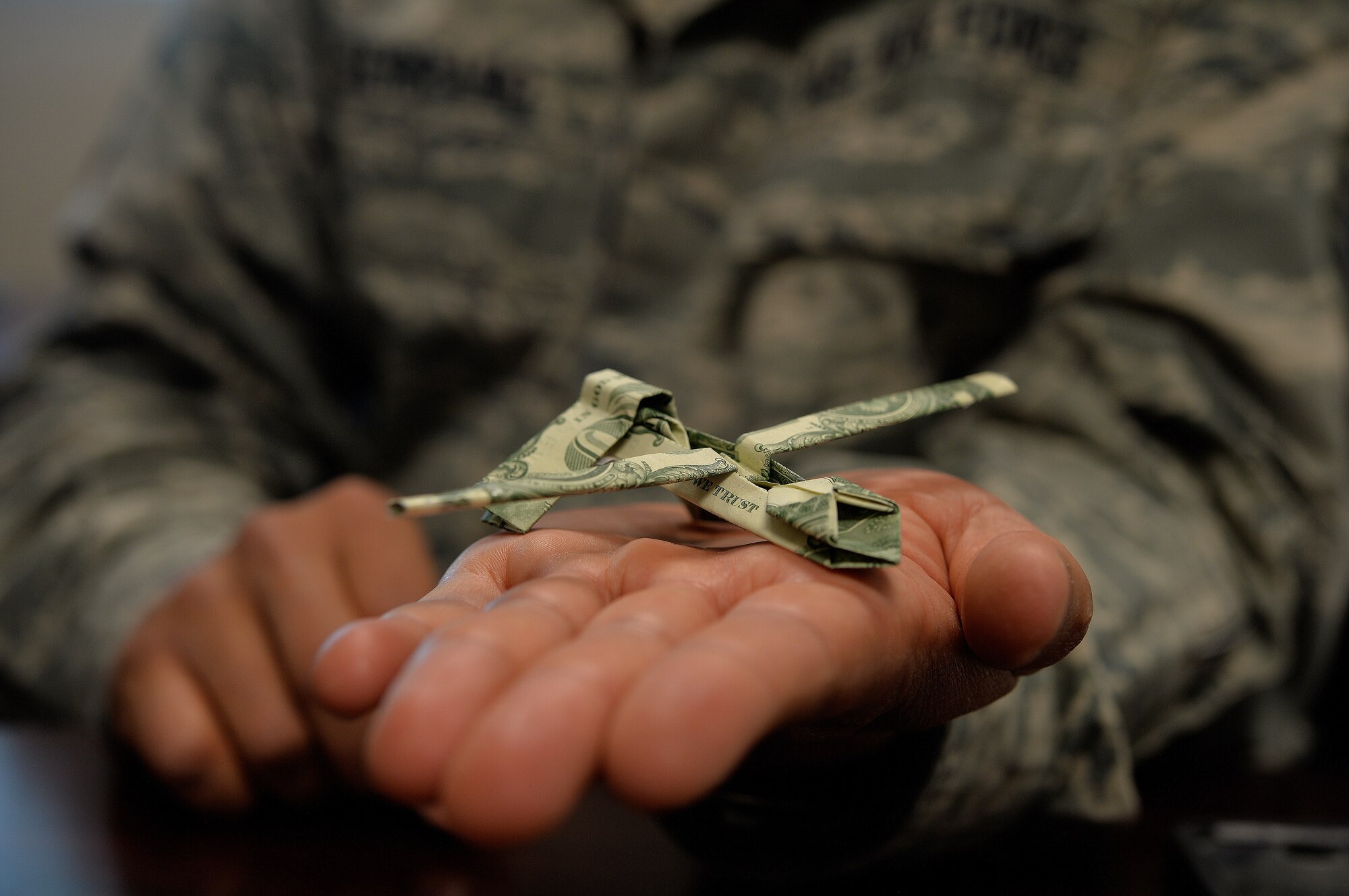 An MQ-1 Predator replica is displayed in the open hand of Master Sgt. Timothy Serrano, 432nd Aircraft Communications Maintenance Squadron first sergeant, April 6, 2015 at Creech Air Force Base, Nevada. This piece is special because it symbolizes the Remotely Piloted Aircraft work-horse of 432nd Wing/432nd Air Expeditionary Wing. According to Serrano, the MQ-1 was one of his most challenging pieces to recreate but one he’s proud to have overcome.  (U.S. Air Force photo by Senior Airman Adarius Petty/Released)