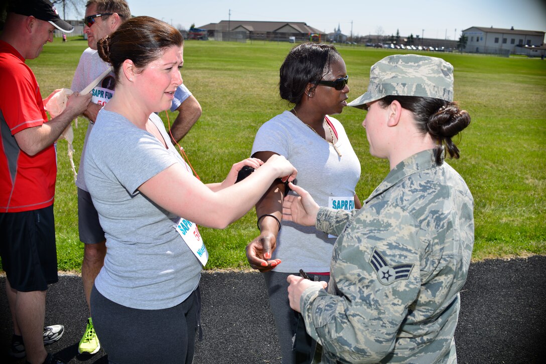 In honor of Sexual Assault Awareness and Prevention month, members of all Military branches participate in the SAPR fun run held at Niagara Falls Air Reserve Station, N.Y., April 29, 2015. The run entails two miles around the base track with various activities along the way, from Self Aid Buddy Care to jumping jacks. (U.S. Air Force photo by Tech. Sgt. Stephanie Sawyer)