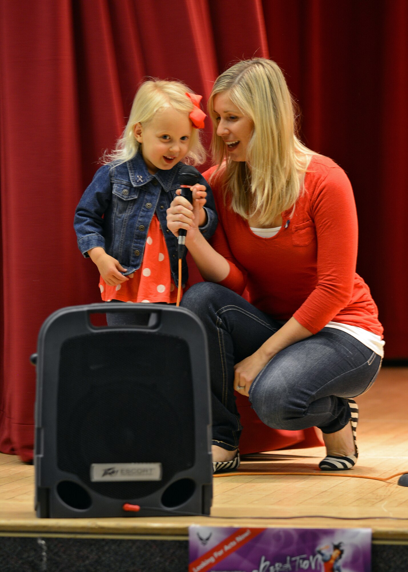 Zella (left), age 3, and Ashley Hausman sing the national anthem to open this year’s “Edwards got Talent” event at the Oasis Community Center which was held April 24. The event was hosted by Family Advocacy and the 412th Medical Group Booster Club to bring awareness during Child Abuse Prevention Month. (U.S. Air Force photo by Jet Fabara)