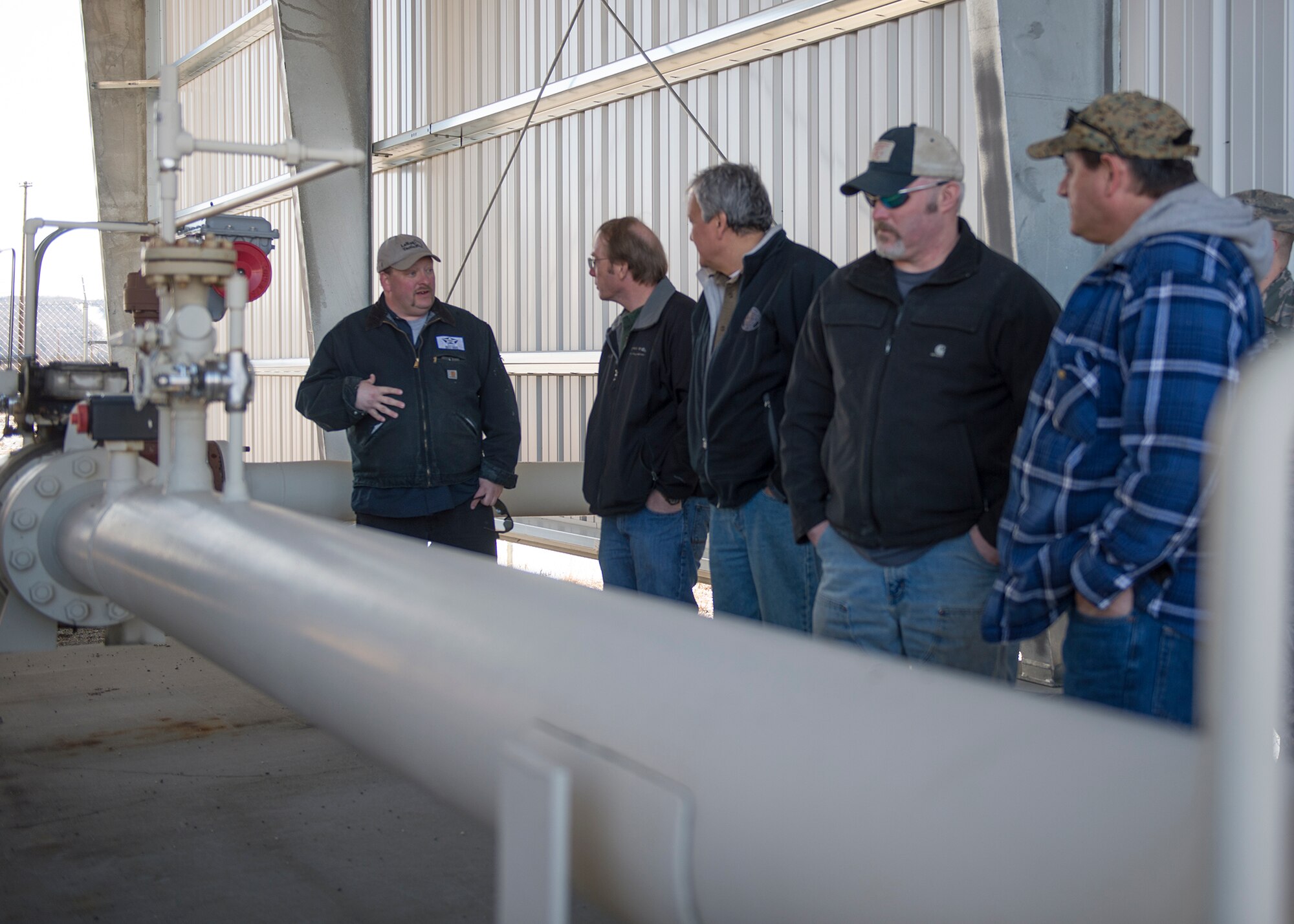 Employees from a local oil refinery and Airmen from the 354th Logistics Readiness Squadron petroleum, oils and liquids flight visit refueling facilities April 21, 2015, at Eielson Air Force Base, Alaska. The refinery supplies the base with fuel weekly to fill 25 million gallons of bulk storage. (U.S. Air Force photo by Staff Sgt. Shawn Nickel/Released)