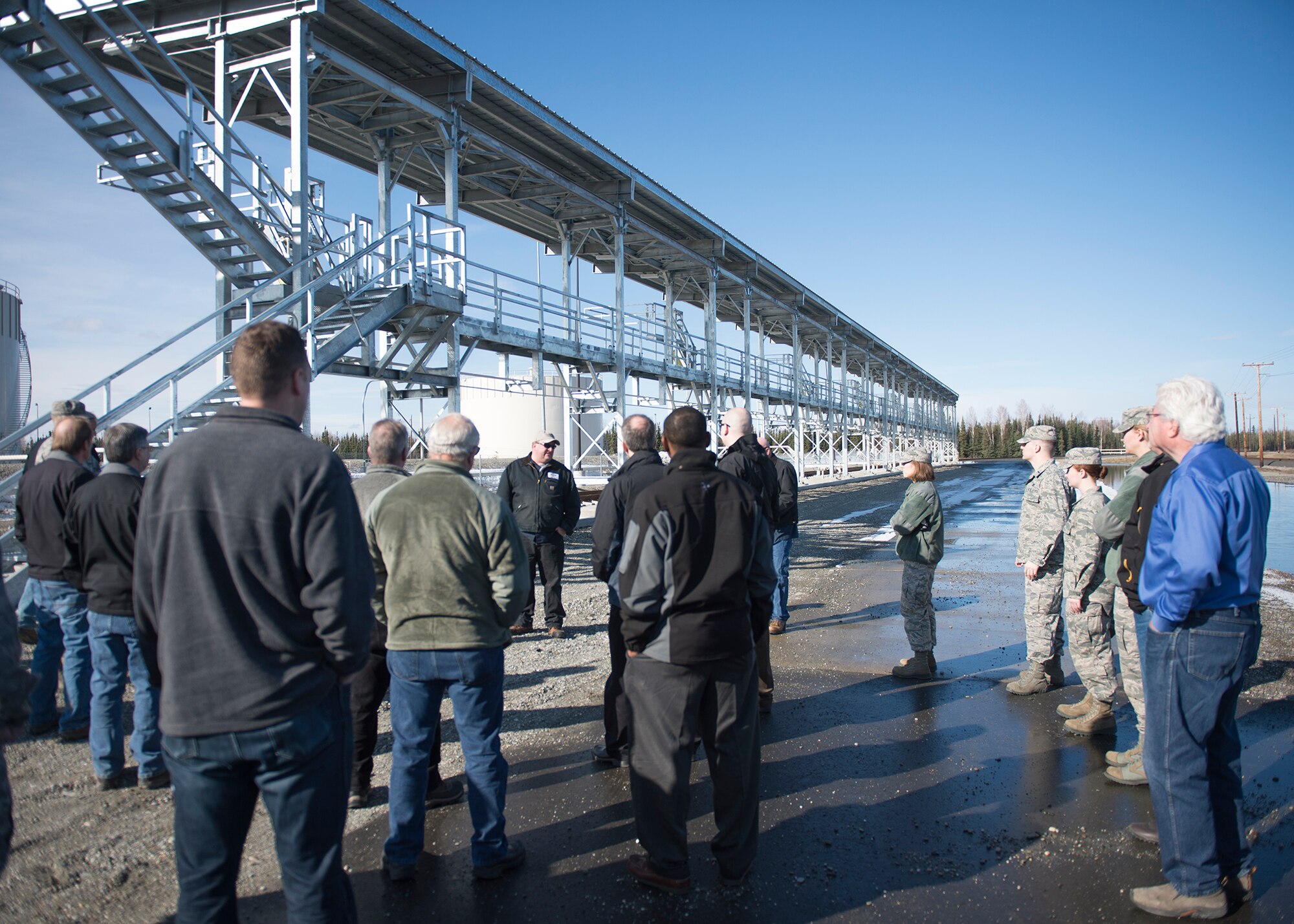 Employees from a local oil refinery and Airmen from the 354th Logistics Readiness Squadron petroleum, oils and liquids flight visit refueling facilities April 21, 2015, at Eielson Air Force Base, Alaska.  The refinery supplies the base with JP-8 directly through an 11-mile pipeline, which saves the Air Force money by allowing the valuable liquid to be delivered through the pipeline rather than by rail or truck. (U.S. Air Force photo by Staff Sgt. Shawn Nickel/Released) 