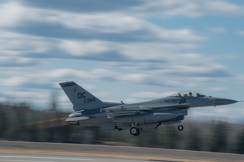 An F-16 Fighting Falcon pilot from the 113th Wing, District of Columbia Air National Guard, takes off from the flight line April 27, 2015 at Eielson Air Force Base, Alaska. The unit is preparing to participate in RED FLAG-Alaska 15-2 large-force employment training. (U.S. Air Force photo by Staff Sgt. Shawn Nickel/Released)